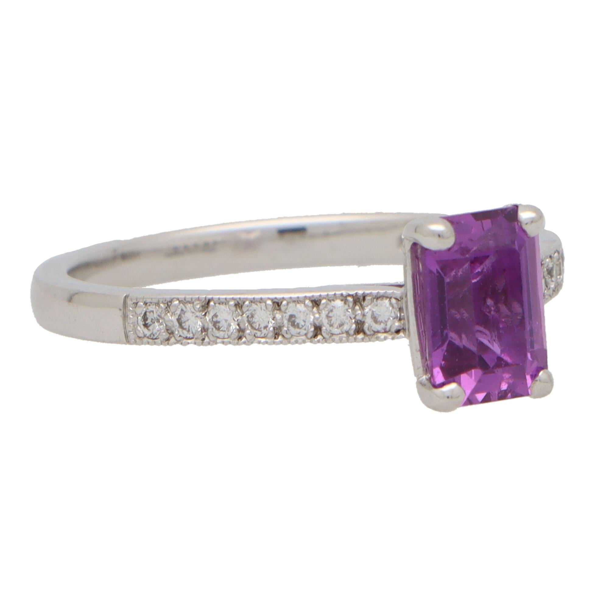 An extremely elegant purple sapphire and diamond solitaire ring set in 18k white gold. 

The piece features a beautiful purple coloured 1.29 carat emerald cut sapphire. The sapphire is four claw set to centre within a raised gallery setting with