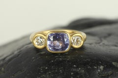 Purple Sapphire and Diamond Three-Stone Bezel Ring