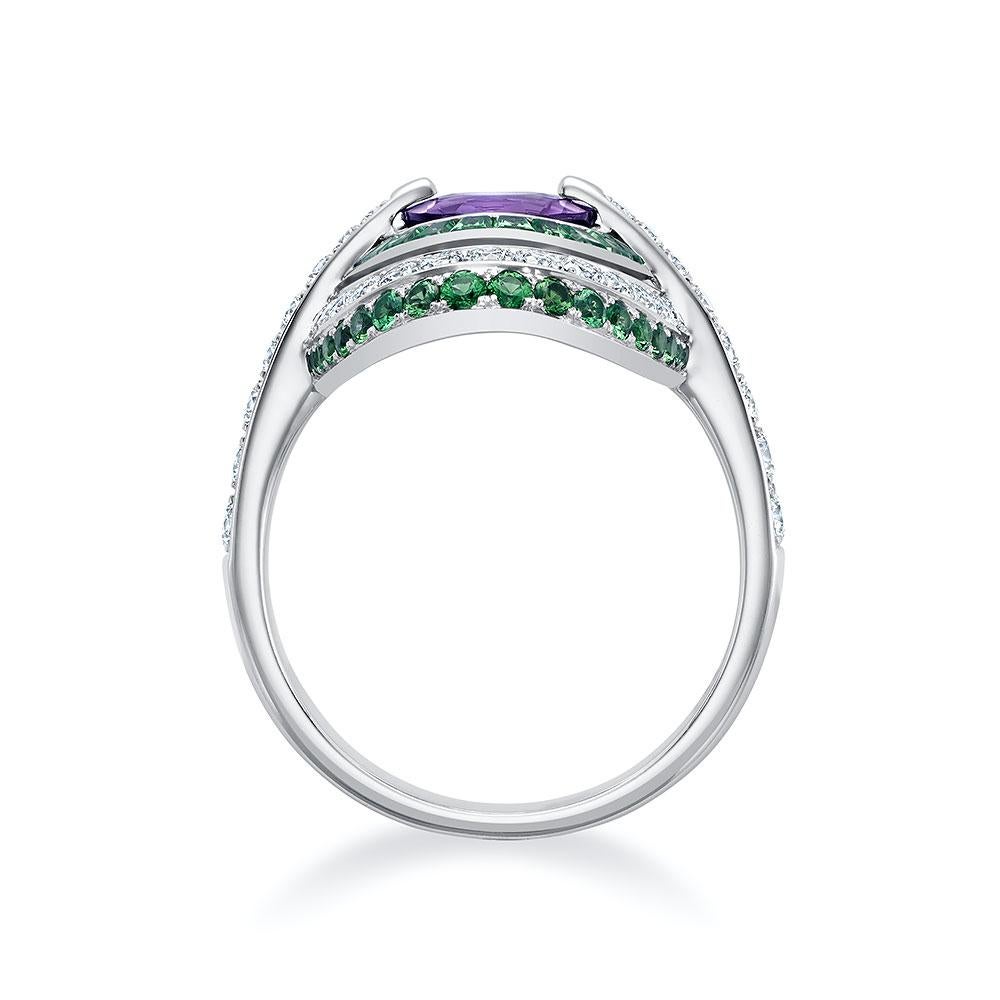 Elevate your style with our stunning 18k white gold ring featuring a round,  1.65-carat majestic purple sapphire at its center. Alternating between vibrant, princess-cut tsavorites totaling 0.89 carats and  by 0.79 carats of round brilliant cut