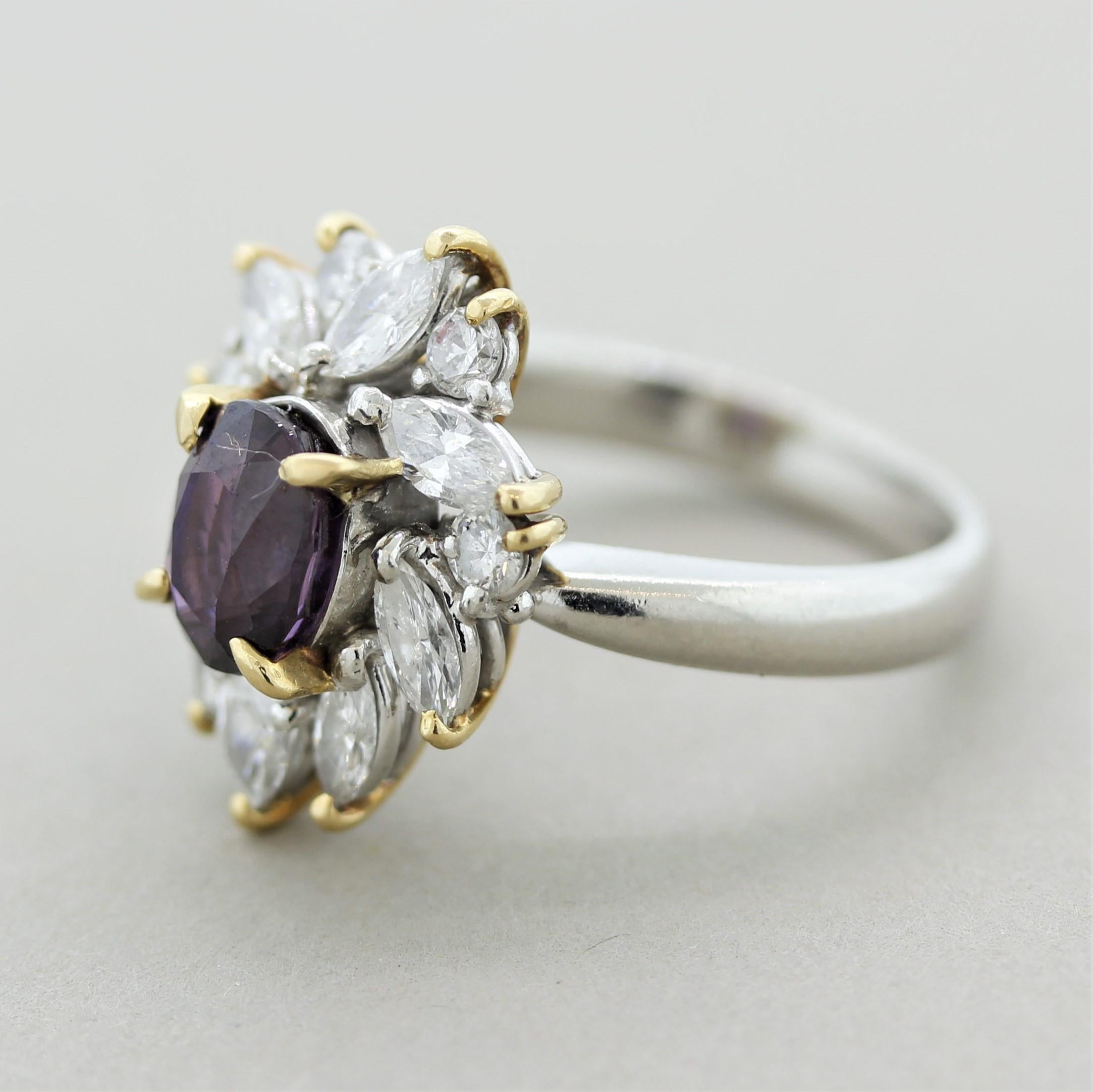 A chic and elegant ring featuring a gem sapphire weighing 2.09 carats with a royal purple color. It is oval shaped and is free of any eye-visible inclusions. It is accented by larger sized diamonds weighing 1.22 carats which halo the sapphire in a