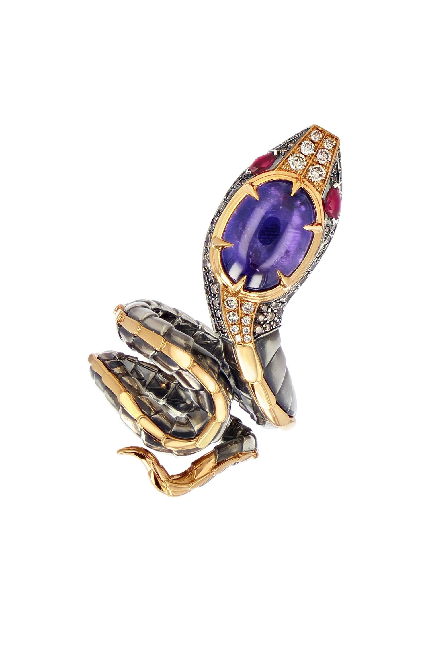 Rose gold and distressed silver ring. The body, wrapped in distressed silver scales with a rose gold dorsal ridge, ends with a head that is paved with diamonds and animated with  rubis eyes. At its summit, it is set with a cabochon cut purple