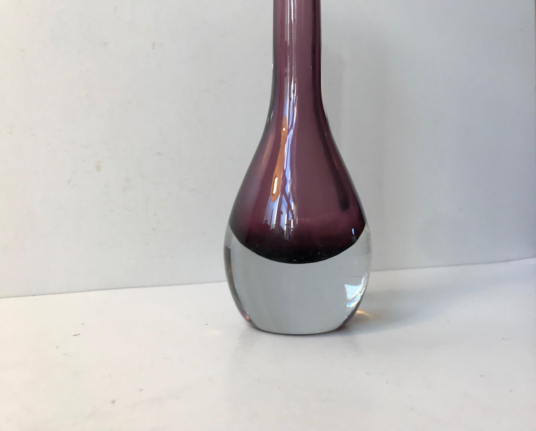 Hand blown glass vase with purple hues. A rare shaped designed by Gunnar Nylund and made at Stormbergshyttan in Sweden during the 1950s. The vase is marked or signed indistinguishable beneath its base.