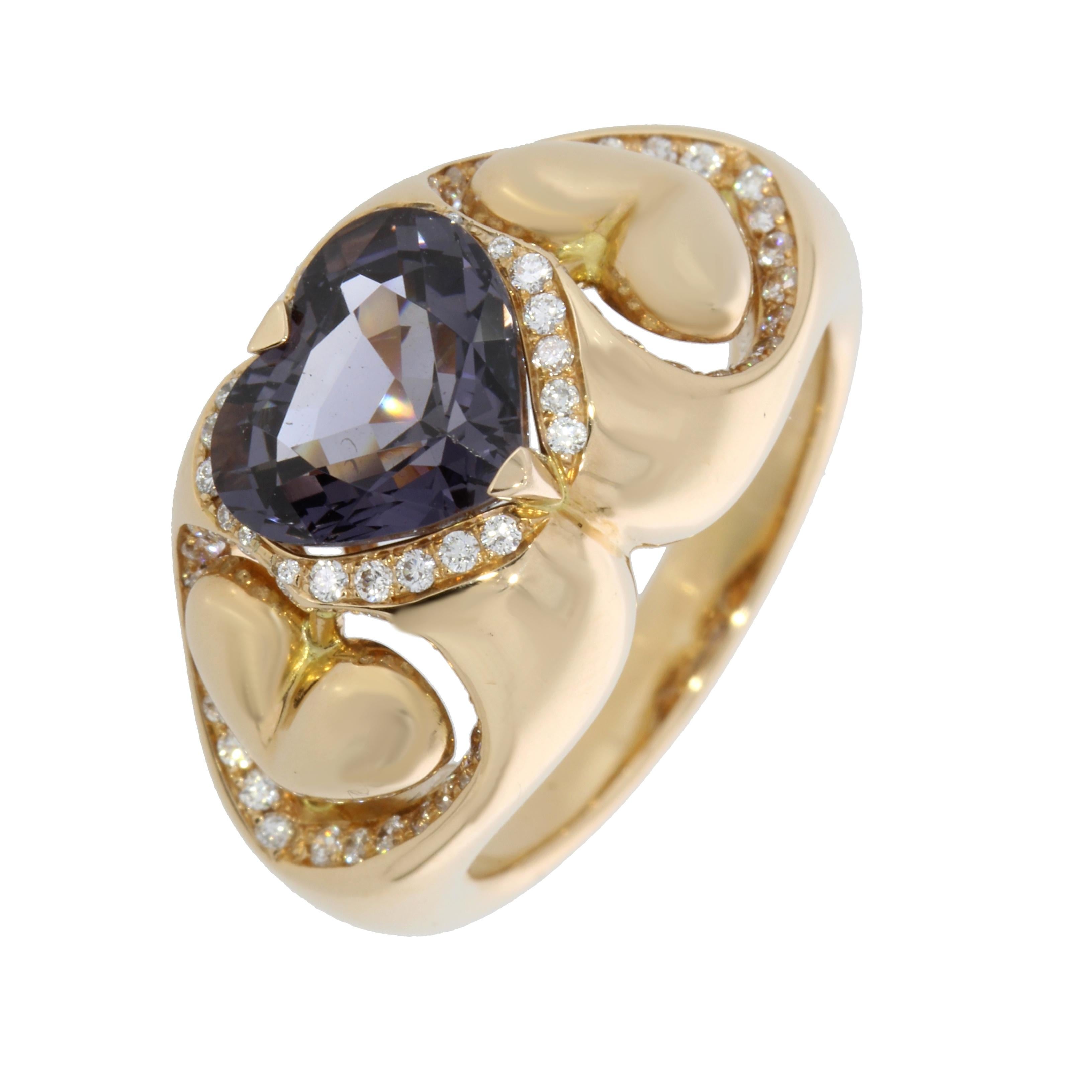 A captivating heart shaped Purple Spinel set between two suspended gold Hearts. The gold hearts are surrounded by a glittering pave of white round brilliant cut diamonds.

This ring is an original new engagement ring but also a the perfect present