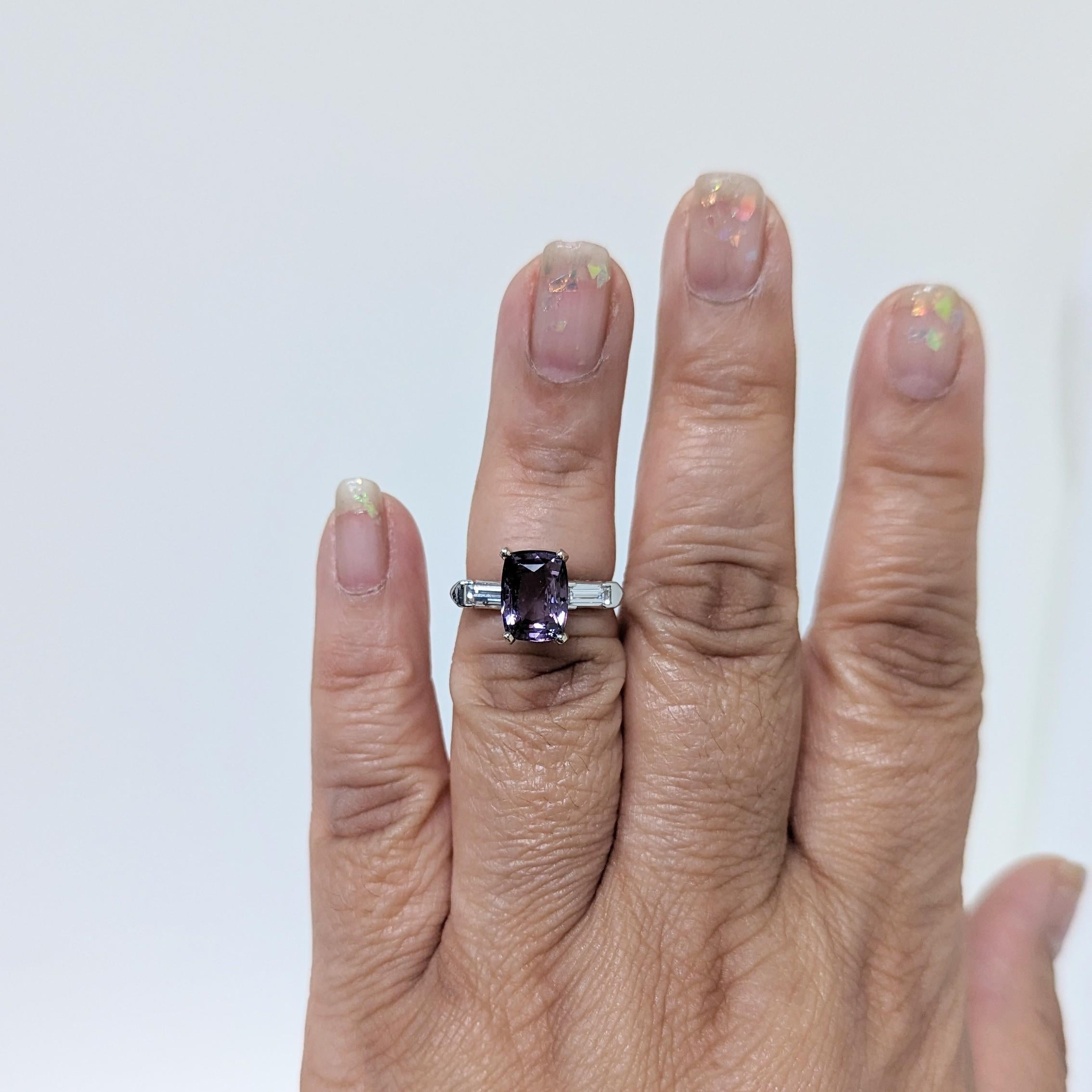 Beautiful 3.97 ct. purple spinel cushion with 0.30 ct. good quality, white, and bright diamond baguettes.  Handmade in platinum.  Ring size 6.25.