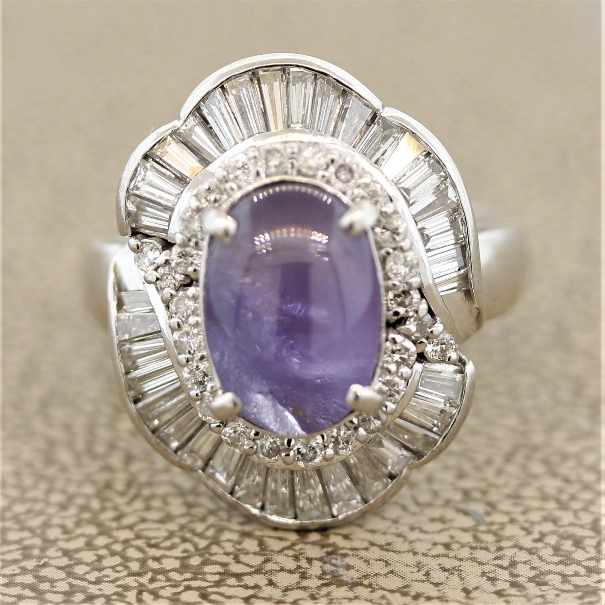A special stone with a unique color! A purple star sapphire weighing 5.10 carats takes center stage of this hand-fabricated platinum ring. It has a sweet lilac purple color rarely seen in star sapphires. When a light hits the top of the stone a 6