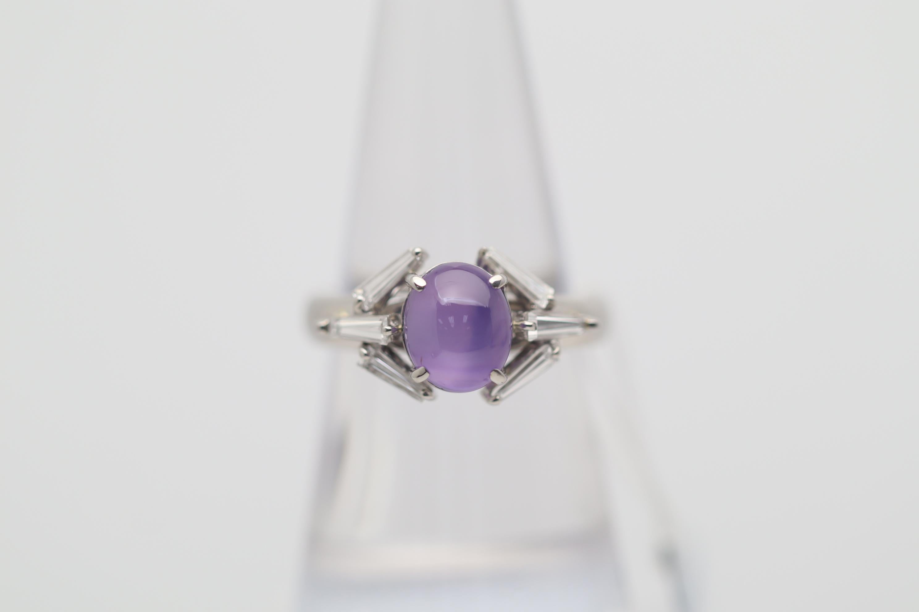 A chic and stylish geometric ring featuring a 3.87 carat star sapphire with a clean rich purple color. The sapphire has excellent clarity along with a strong 6-rayed star making the stone a true gem. It is complemented by 6 baguette-cut diamonds