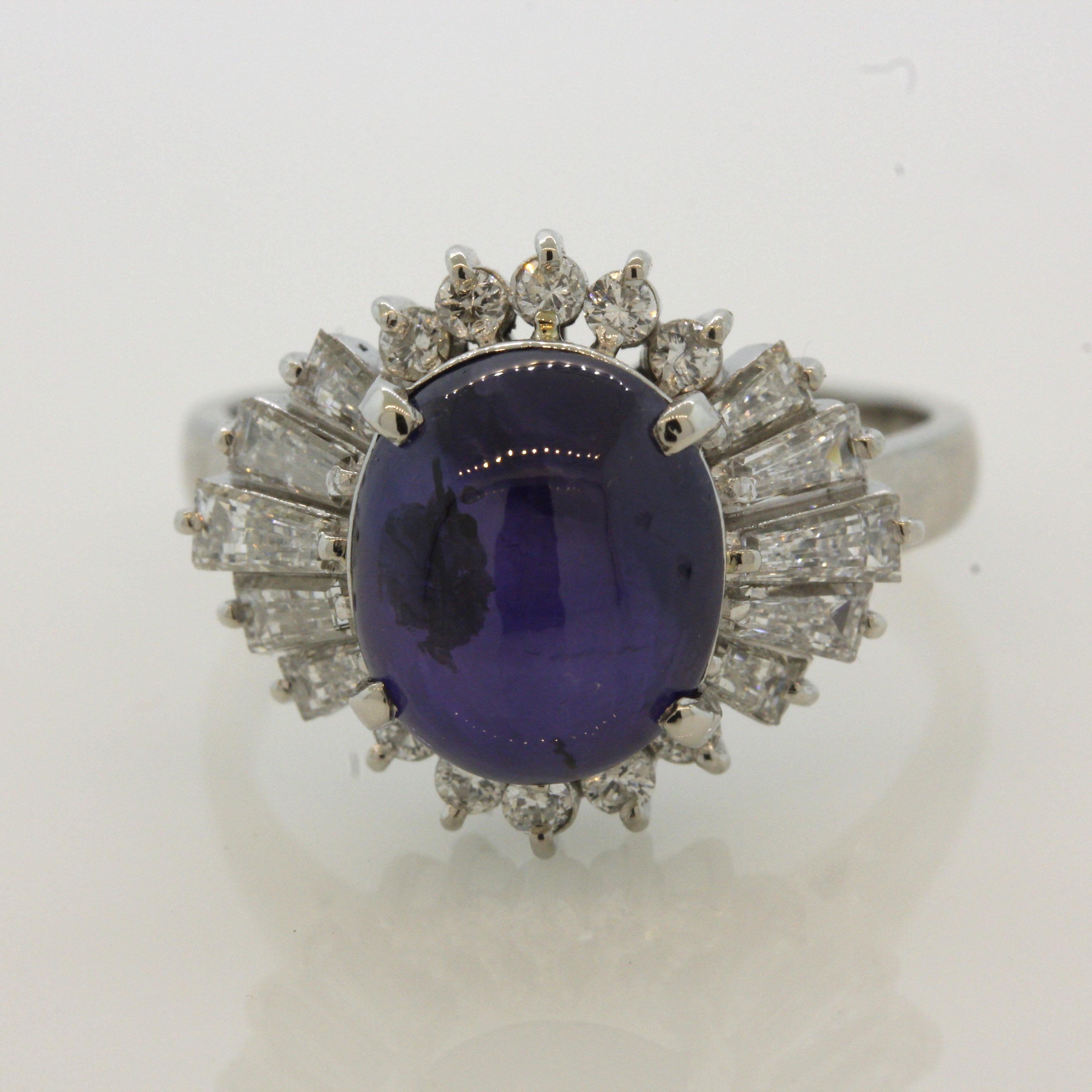 A beautiful richly colored natural star sapphire takes center stage of this platinum made ring. It weighs 7.06 carats and has a rich glowing purple color along with a complete 6-rayed star on its center when a light hits its top. It is complemented