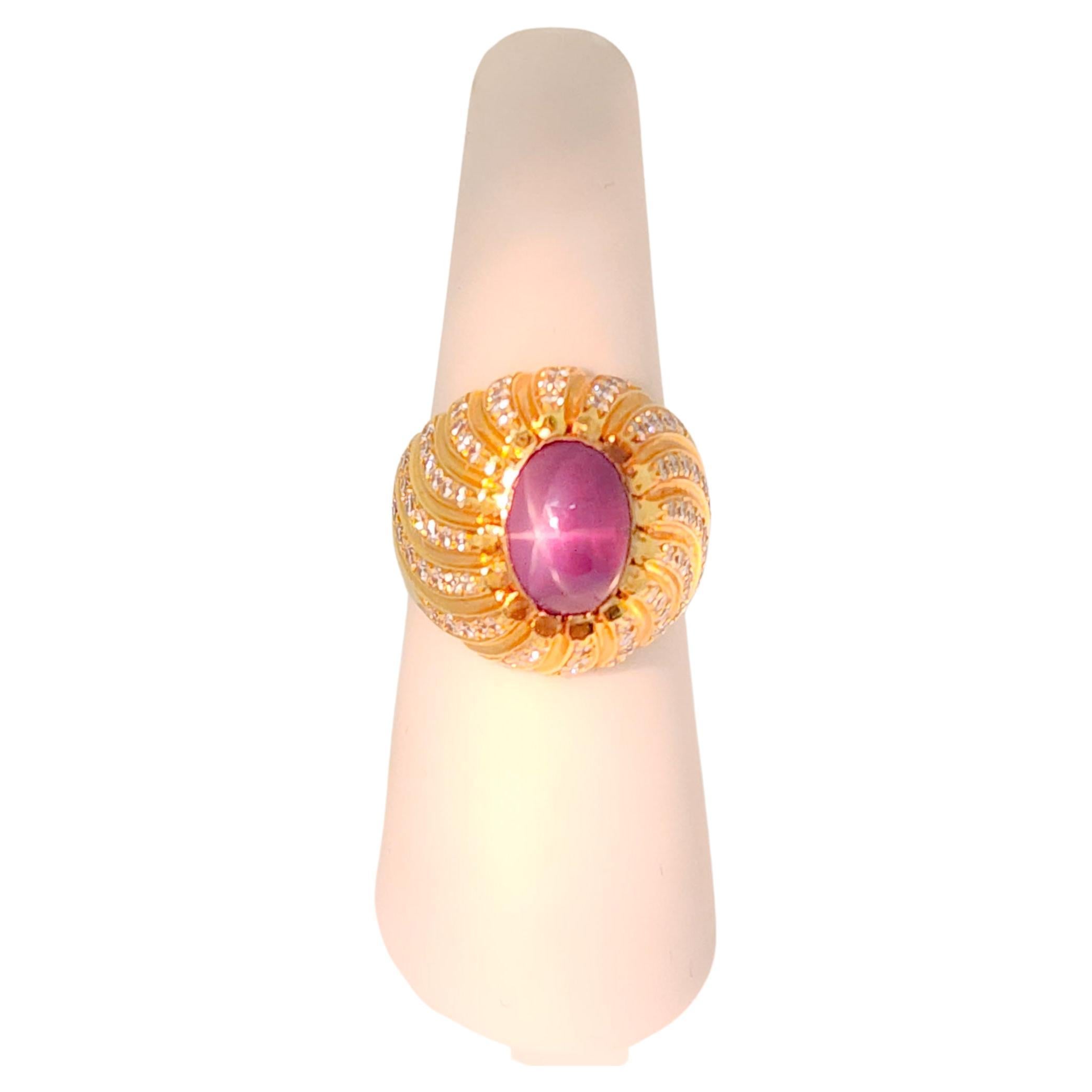 Beautiful purple star sapphire oval cabochon with good quality white diamond rounds.  Handmade in 18k rose gold.  Ring size 7.25.