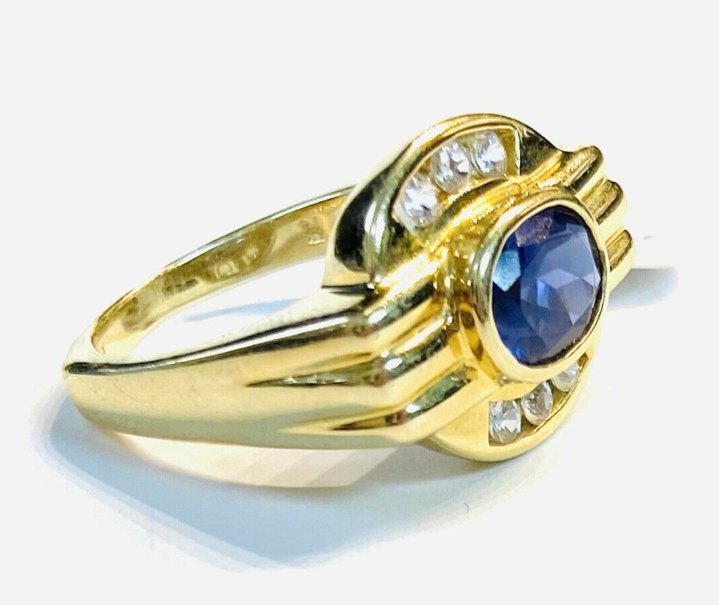 14k yellow gold purple tanzanite and diamond ring, 6.01 Grams TW. The dimensions of the oval tanzanite are approximately 8 mm x 5.5 mm. Approximately 1 carat. Marked 14k. Approximate size 7.