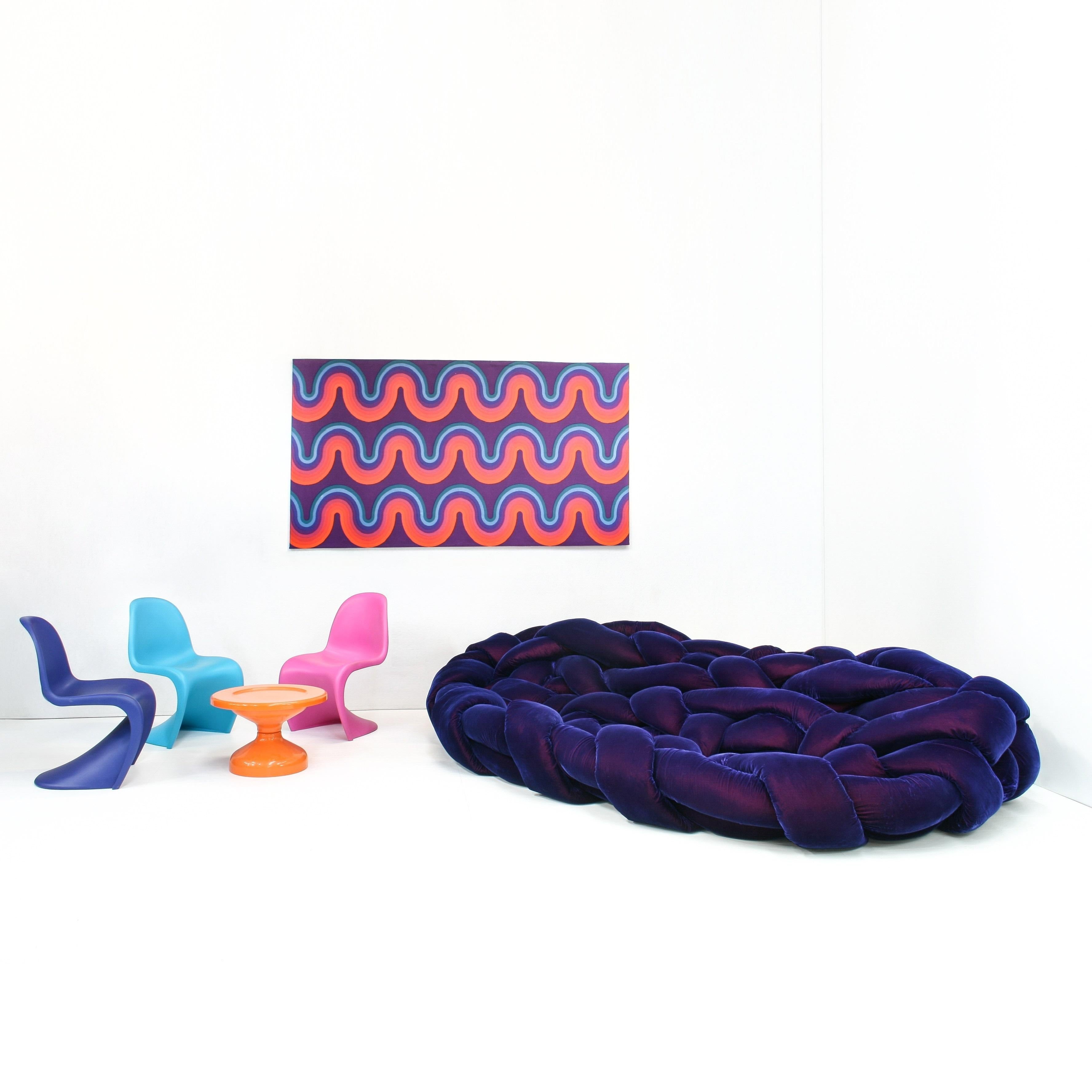 The Boa sofa by Edra is a large woven nest. A soft embrace. An invitation to explore different positions lying between its pillows. You can sit on it, lie down or curl up. with no frame, it consists of 120 meters of tube filled with flexible and