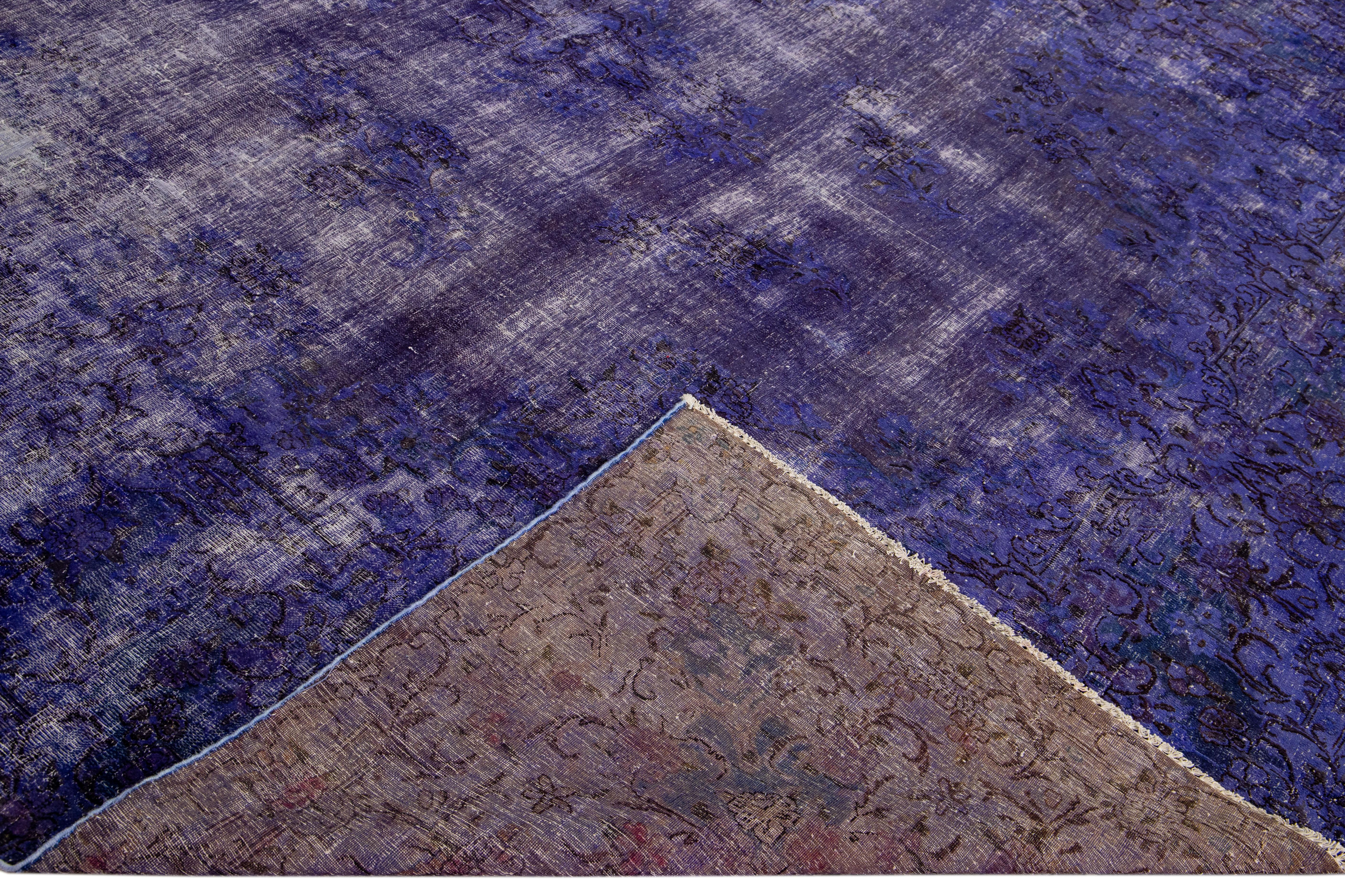 Beautiful Vintage overdyed hand-knotted oversize wool rug with a purple field. This overdyed rug has ivory and brown accent in an all-over floral design.

This rug measures: 9'8' x 15'7