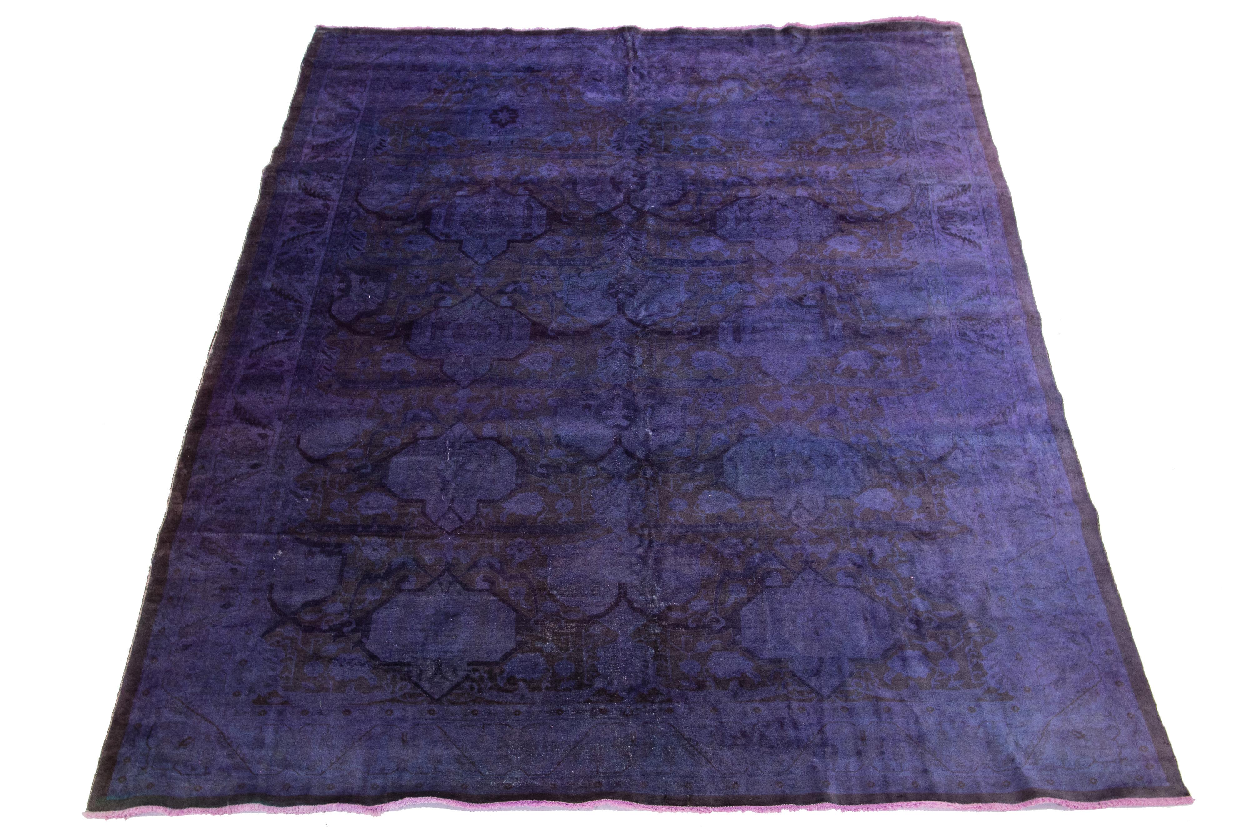 Beautiful Vintage overdyed hand-knotted wool rug with a purple field. This Persian rug has brown accents in an all-over floral design.

This rug measures 8'4'' x 13'9