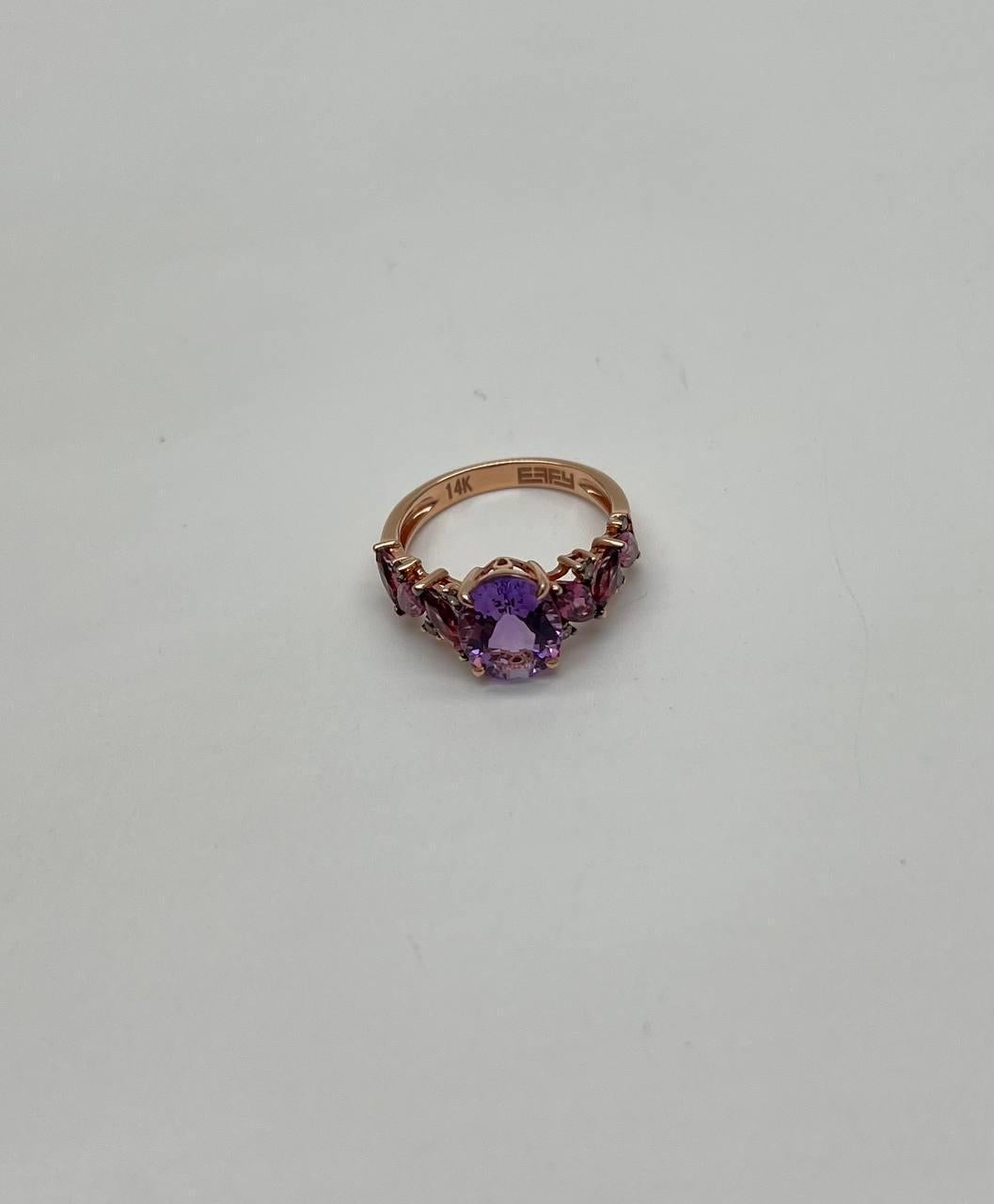 This exquisite ring features a stunning round-cut amethyst as the centerpiece, flanked by smaller rhodolite garnets stones. The band is crafted in 14K rose gold, adding a warm and luxurious touch. 14K Rose Gold. 4 Ctw Amethyst and Rhodolite Garnets.