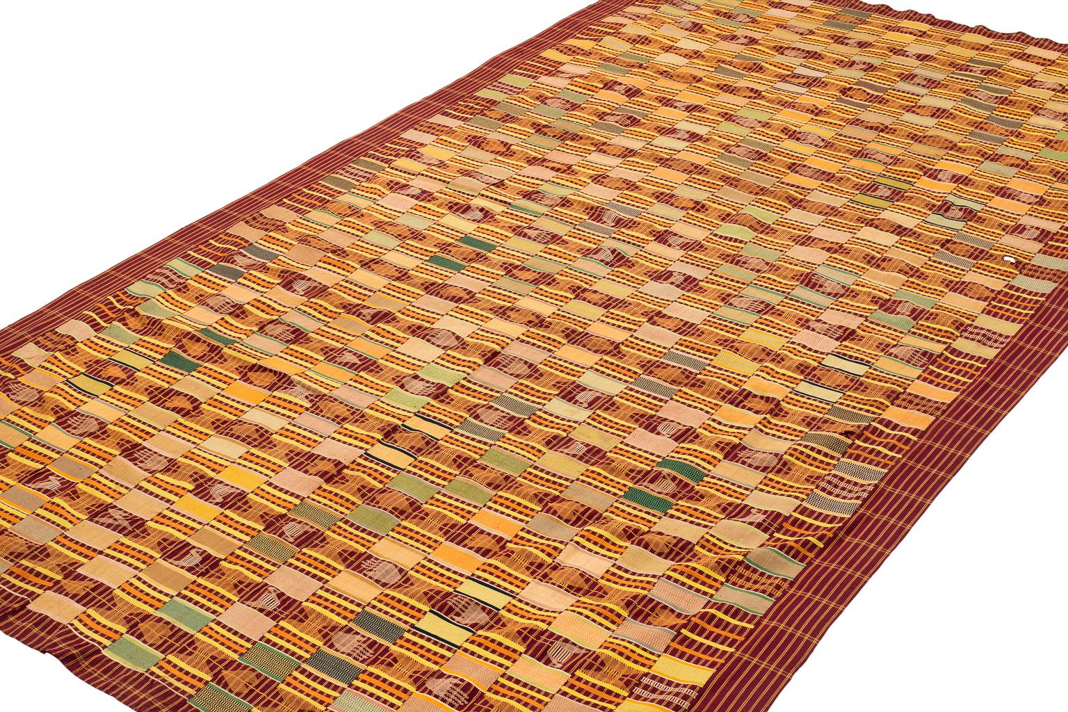 This African Men's Ewe Kente cloth has a light aubergine purple background with highlights of orange, yellow, light green, light blue and dark blue amongst other colors.

It is a very royal weaving in that it has a lot of figures woven into it.