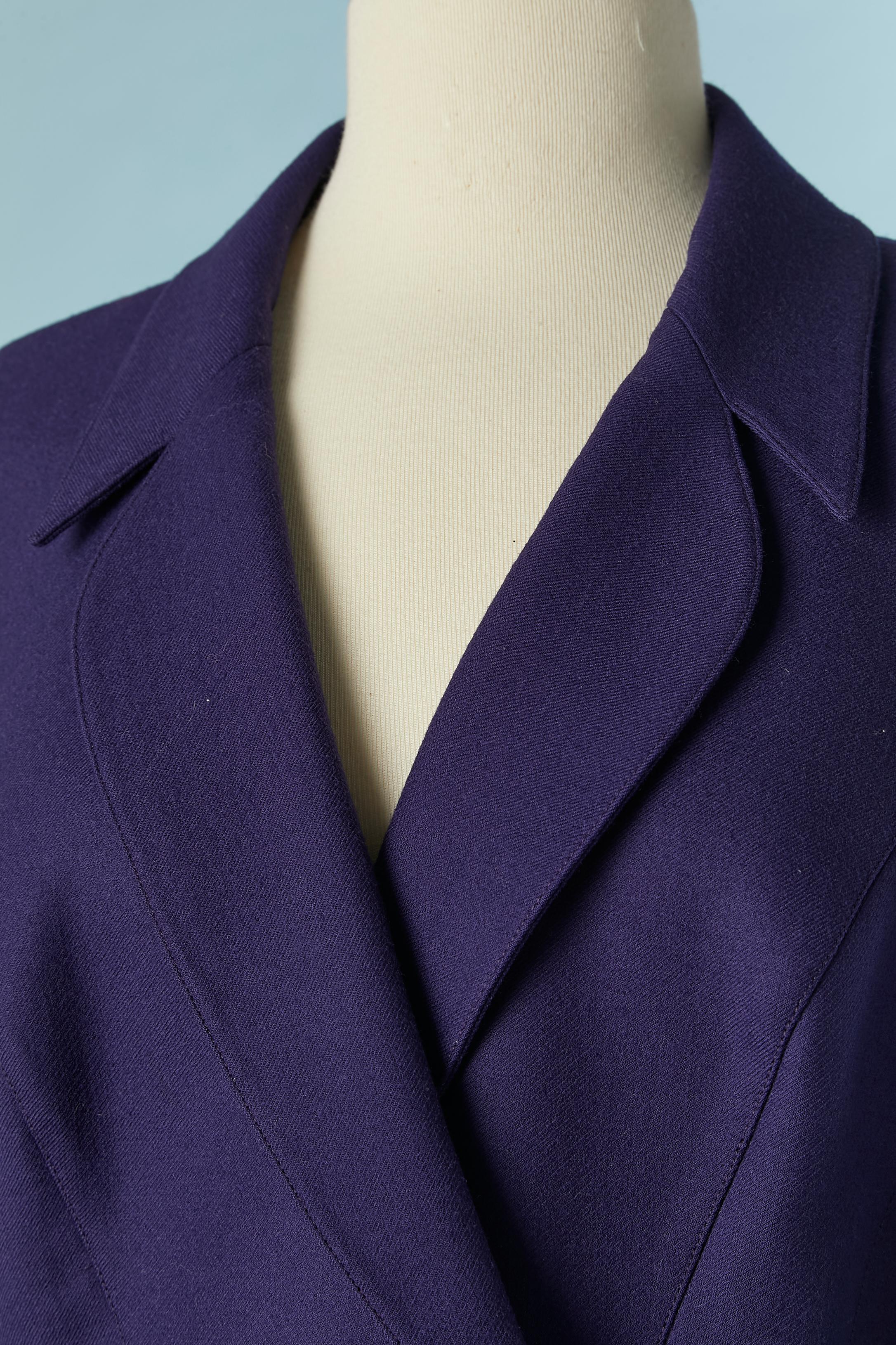 Purple wool double-breasted jacket. The fabric composition tag has been cut but the lining is probably in acetate. Snap closure on the waist under the silver metal buckle. Cut-work. 
SIZE 42 (Fr) L 