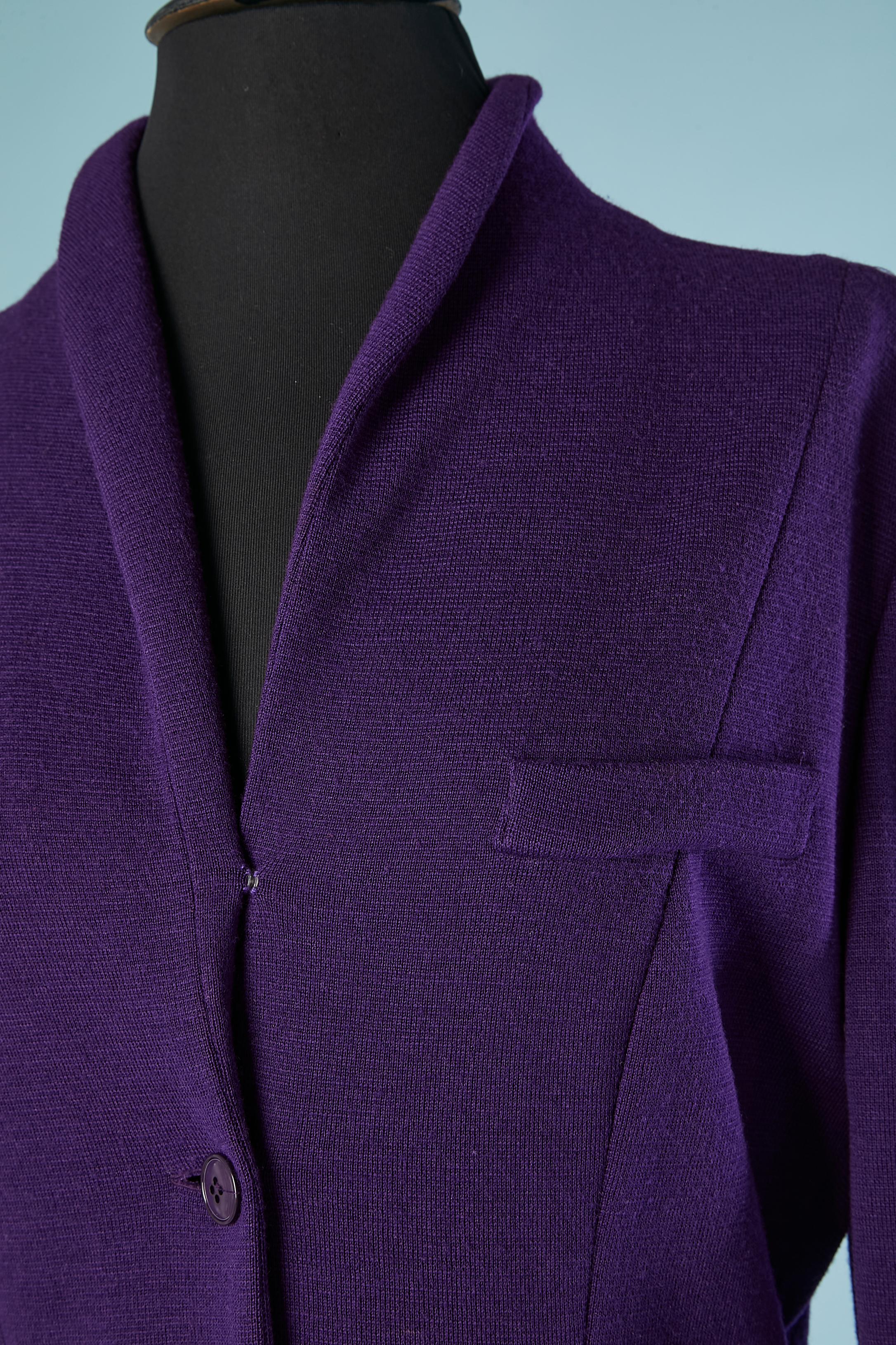 Purple wool jersey dress. Button and buttonhole in the middle front + one plastic snap on the middle top ( above the top button) 
2 pockets on the side of the hips + one 