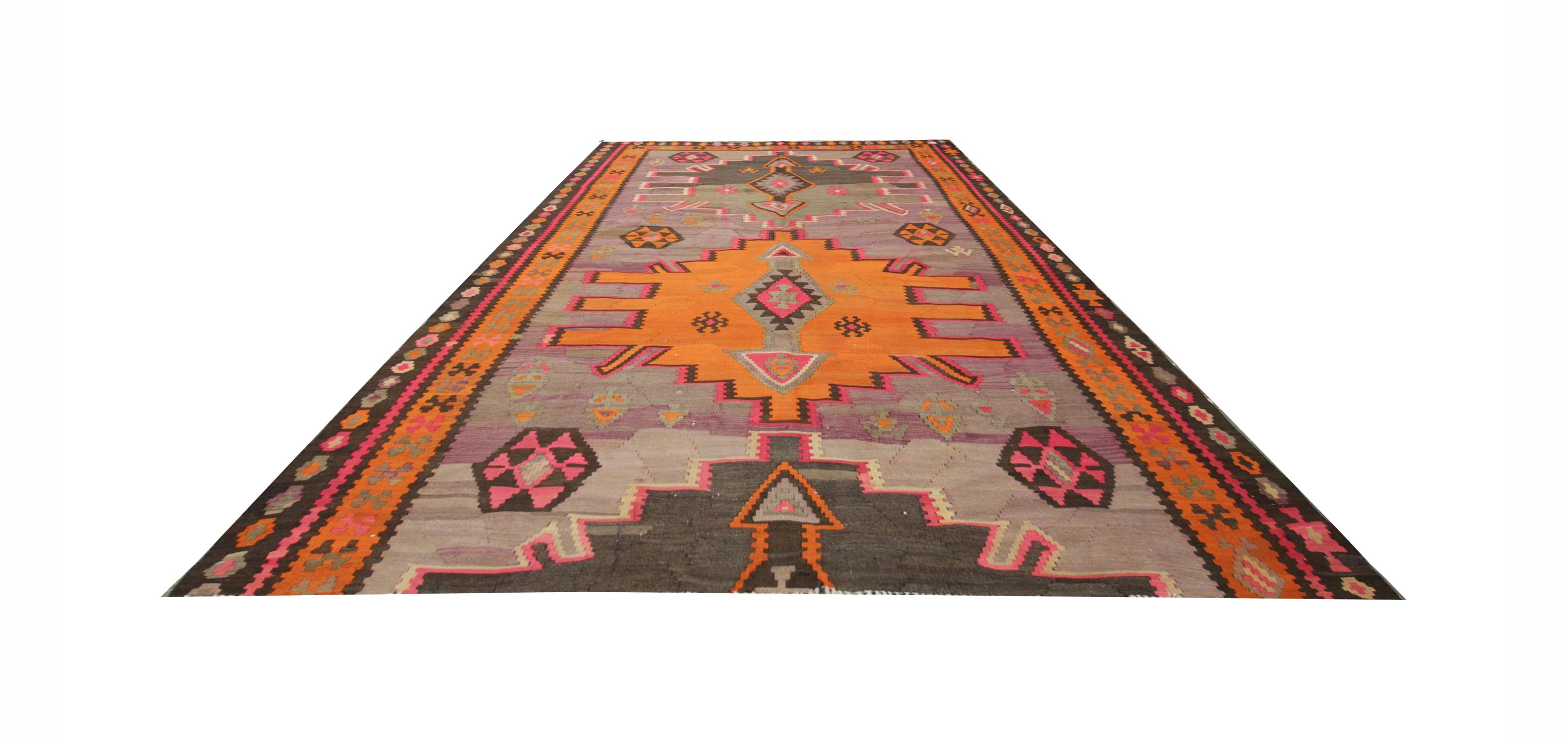 This fine wool rug is a handwoven Caucasian Kilim rug. Tones of red, orange, green and yellow marry together to form this beautiful geometric design, with symbolic details drawn from nature, leaves and animals. The colours and patterns in this rug