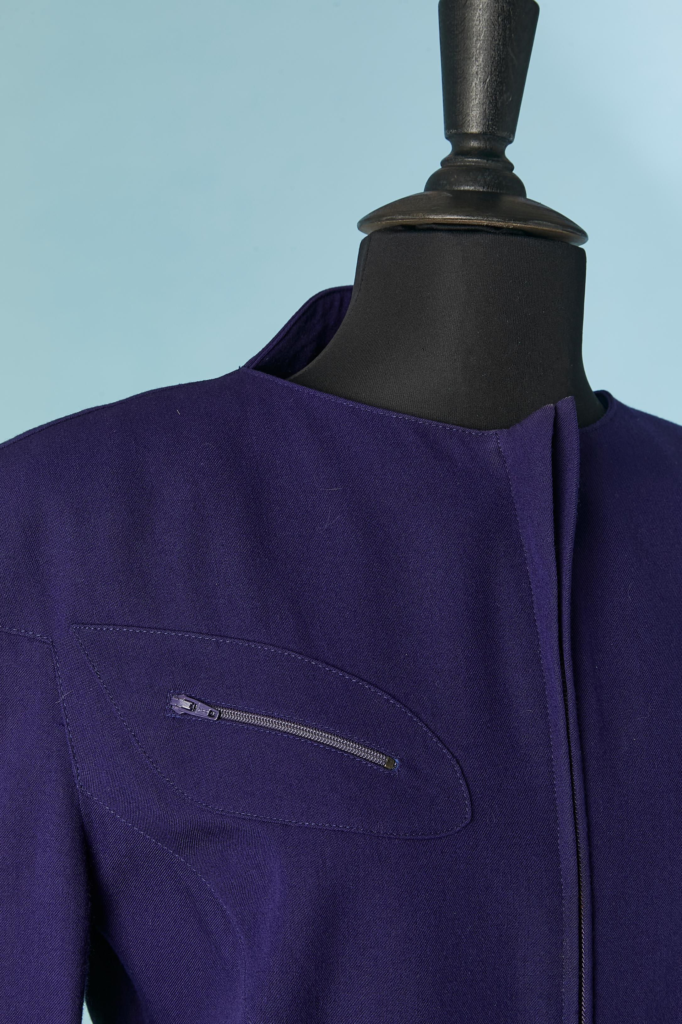 Purple wool skirt-suit. No fabric composition tag for the lining but probably rayon.
Shoulder pad. Zip closure middle front. Zip on the chest pocket as well. Cut-work. 
SIZE 44 (Fr) L 