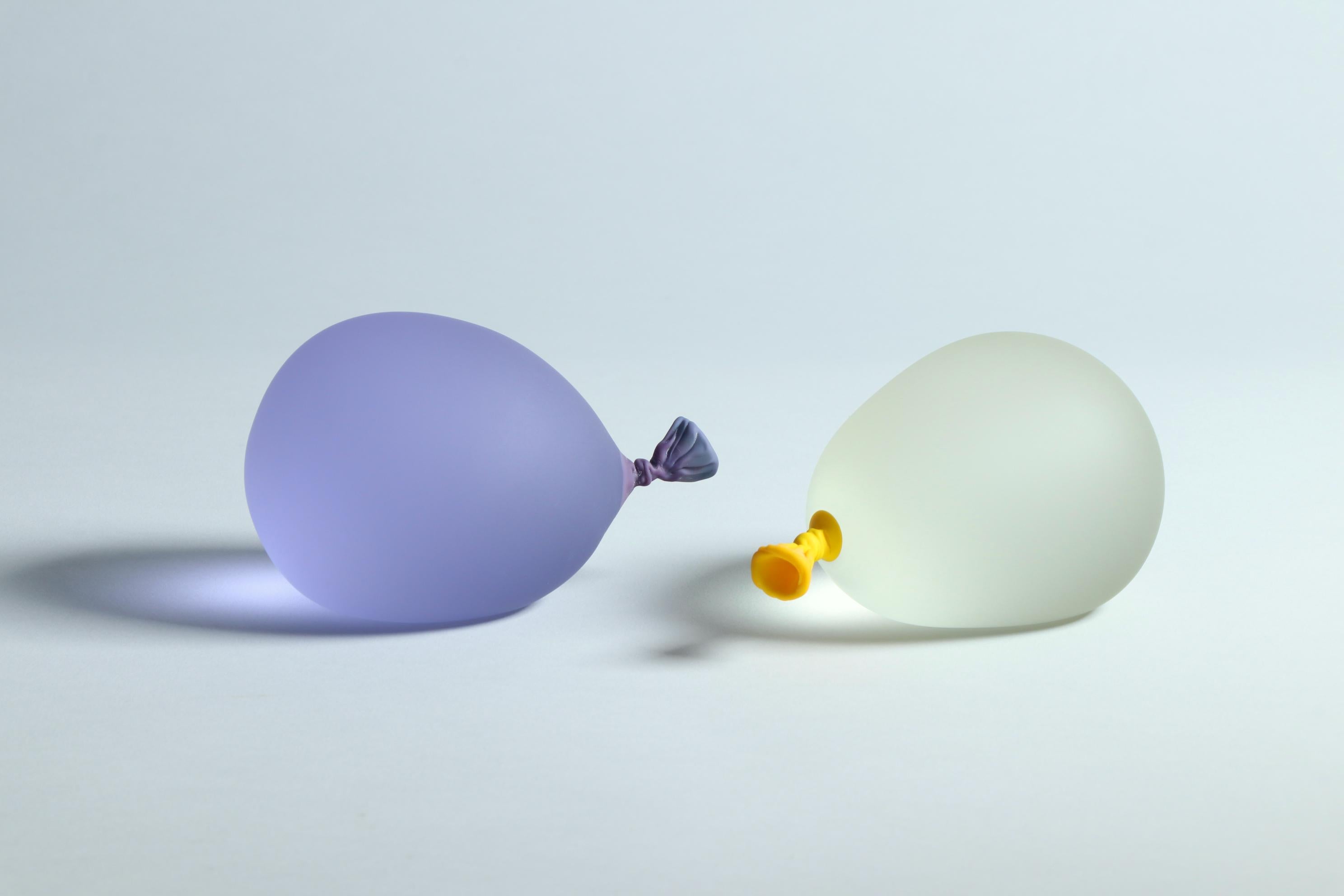 Dylan Martinez’s hyperrealistic water balloons are made of solid sculpted glass sandblasted and acid-etched to resemble real water balloons. The sculptures are made in small batches, and each color is hand-mixed. Each piece is unique and is signed