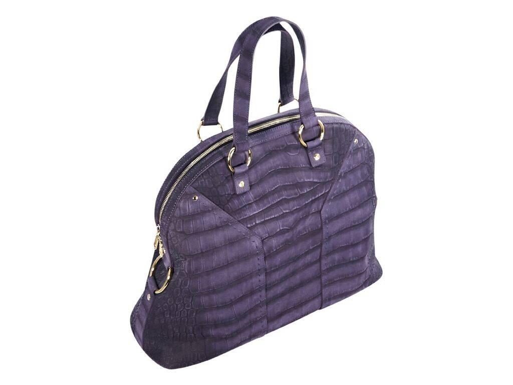 Product details:  Purple embossed leather Muse handbag by Yves Saint Laurent.  Dual carry handles.  Top zip closure.  Lined interior with inner zip and slide pockets.  Protective metal feet.  Goldtone hardware.  Authenticity card included.  20