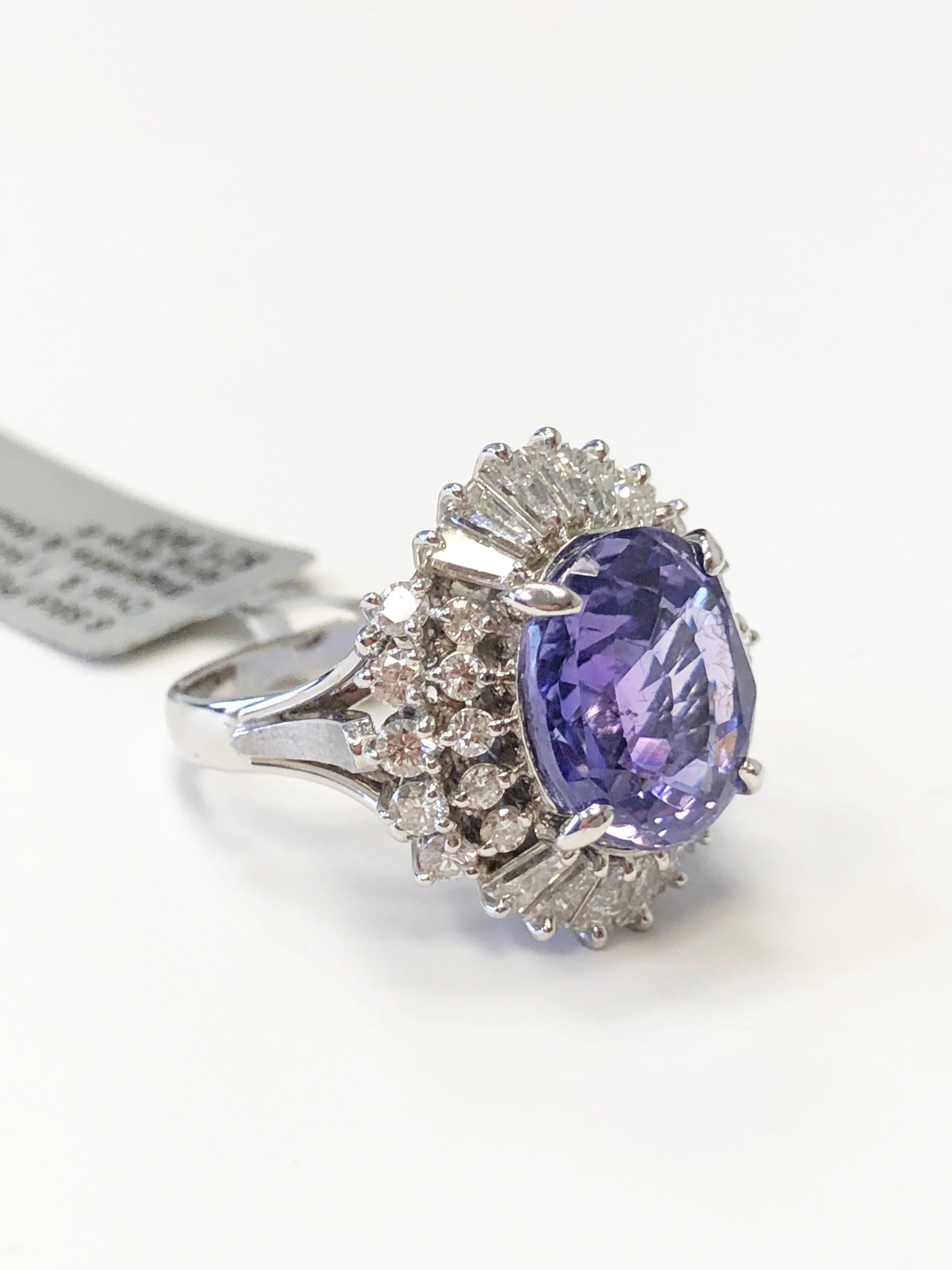 Gorgeous 6.59 carat purplish blue sapphire oval with 1.64 carats of bright white diamond rounds and baguettes.  Handmade dainty platinum mounting size 6. Perfect to elevate your outfit for any occasion!


