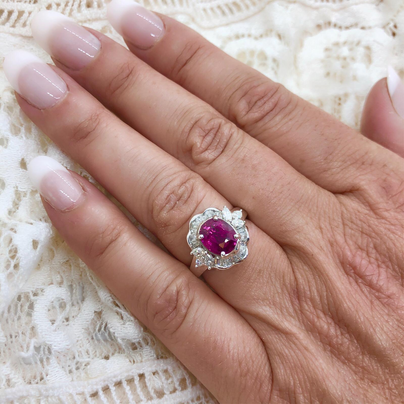 18Kt White Gold Ring features 1 Cushion Cut Purplish Red Ruby for 2.71cts with 28 Marquise and Tapered Baguette Cut Diamonds for approximately 0.75cts Set Halo Style around the Ruby. The ring is a size 7, and weighs 8.1 grams. GIA Certificate