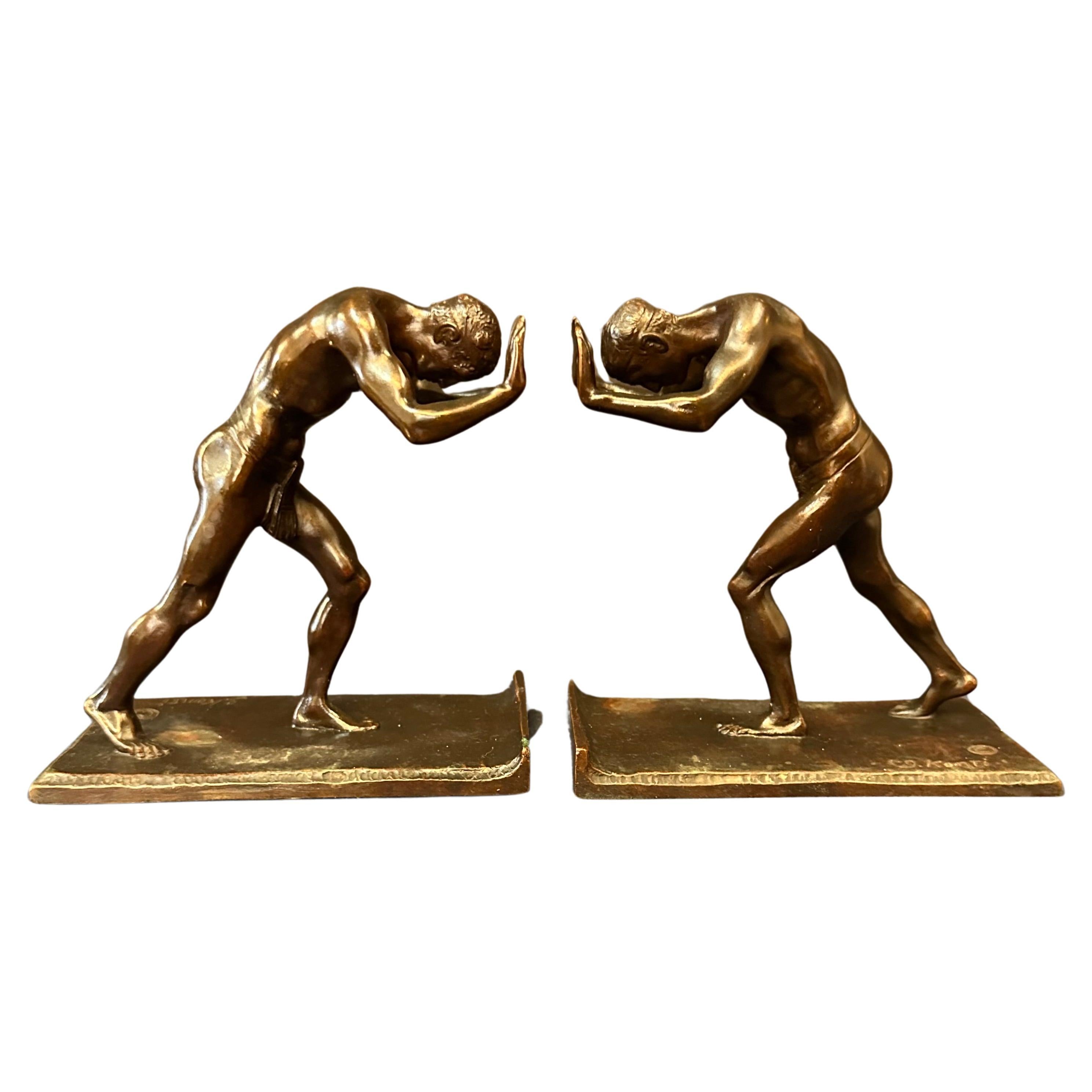 Pushing Men, A Pair of Bookends For Sale