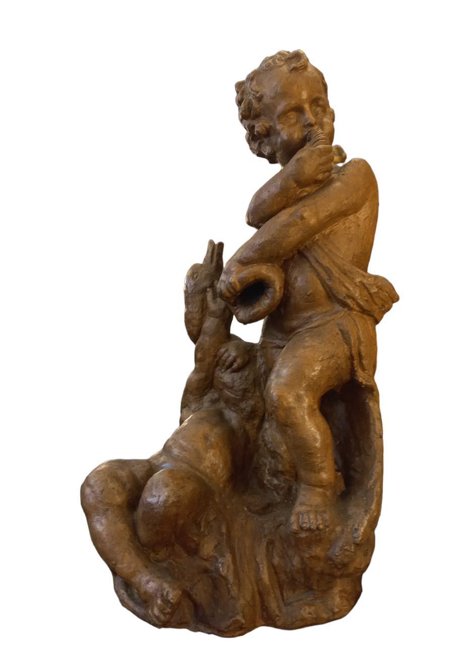 Putti with swan, 18th-century terracotta, height 64 cm base 30x34 cm.
In all likelihood this group is a model for a central fountain sculpture, one child holds high the head of a swan and the other blows inside a shell.