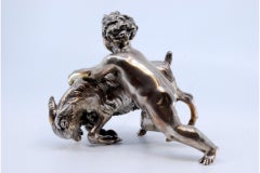 Putti figure with animal in silver