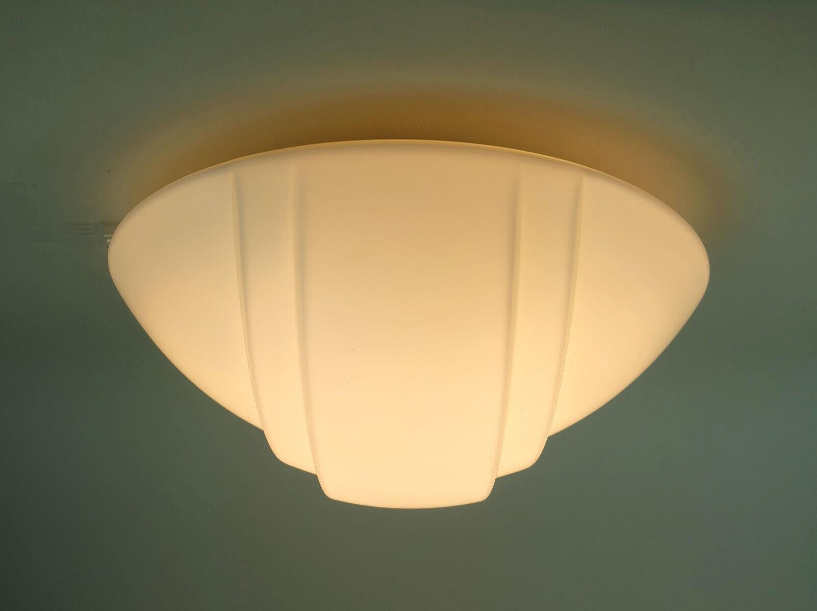Ceiling fixture manufactured by Putzler in the 1970s to 1980s. Model 71292. Matt white opaline glass shade, base white lacquered metal. Holds 1 E27 light bulb each.

A pair of matching sconces is available.

Dimensions in cm: 
Diameter 32 cm, depth