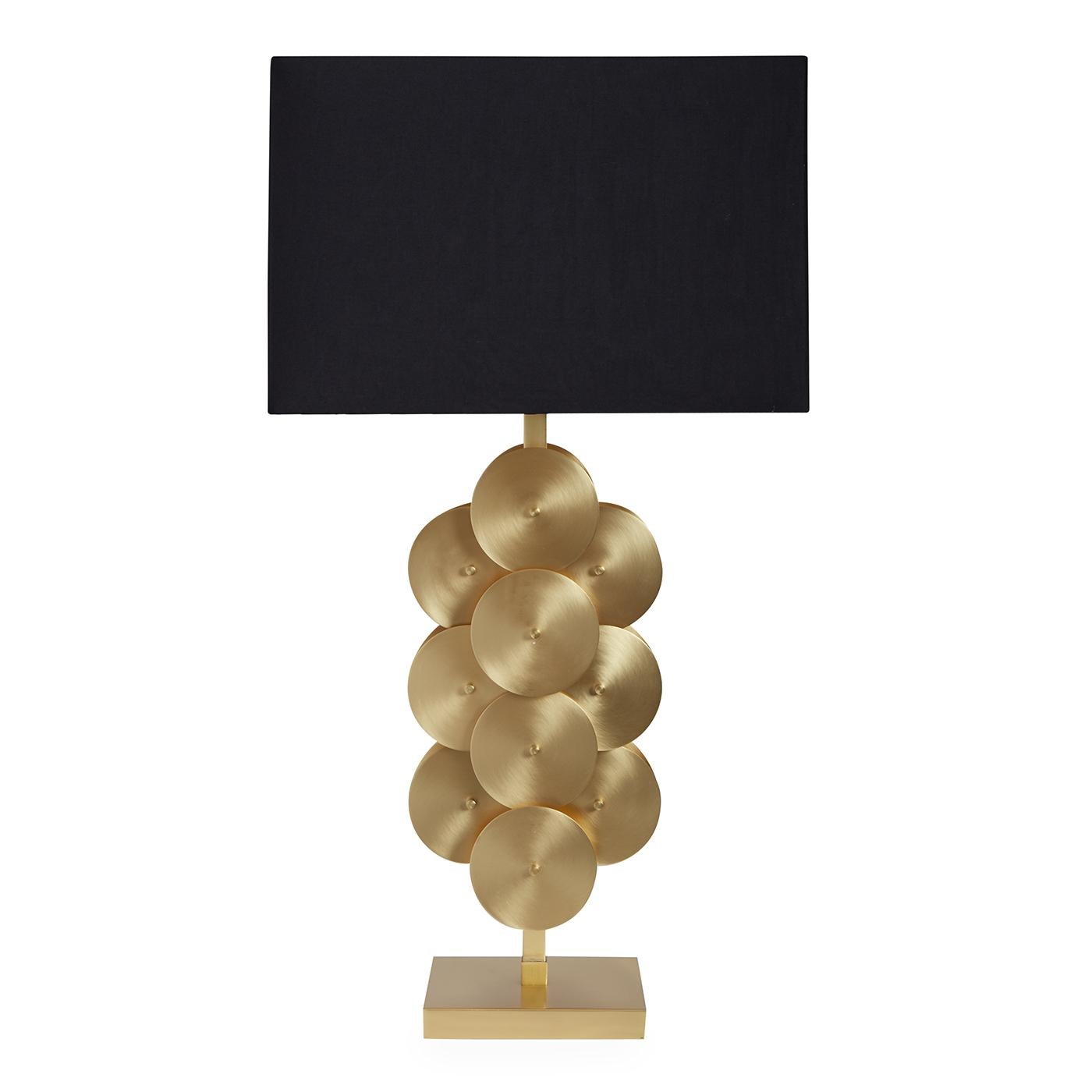 Architectural modernism. A new take on our original house-of-cards-inspired design, our Puzzle Circles Table Lamp is made of brushed brass discs layered in a dynamic composition and is topped with a silky black shade. The architectural modernist