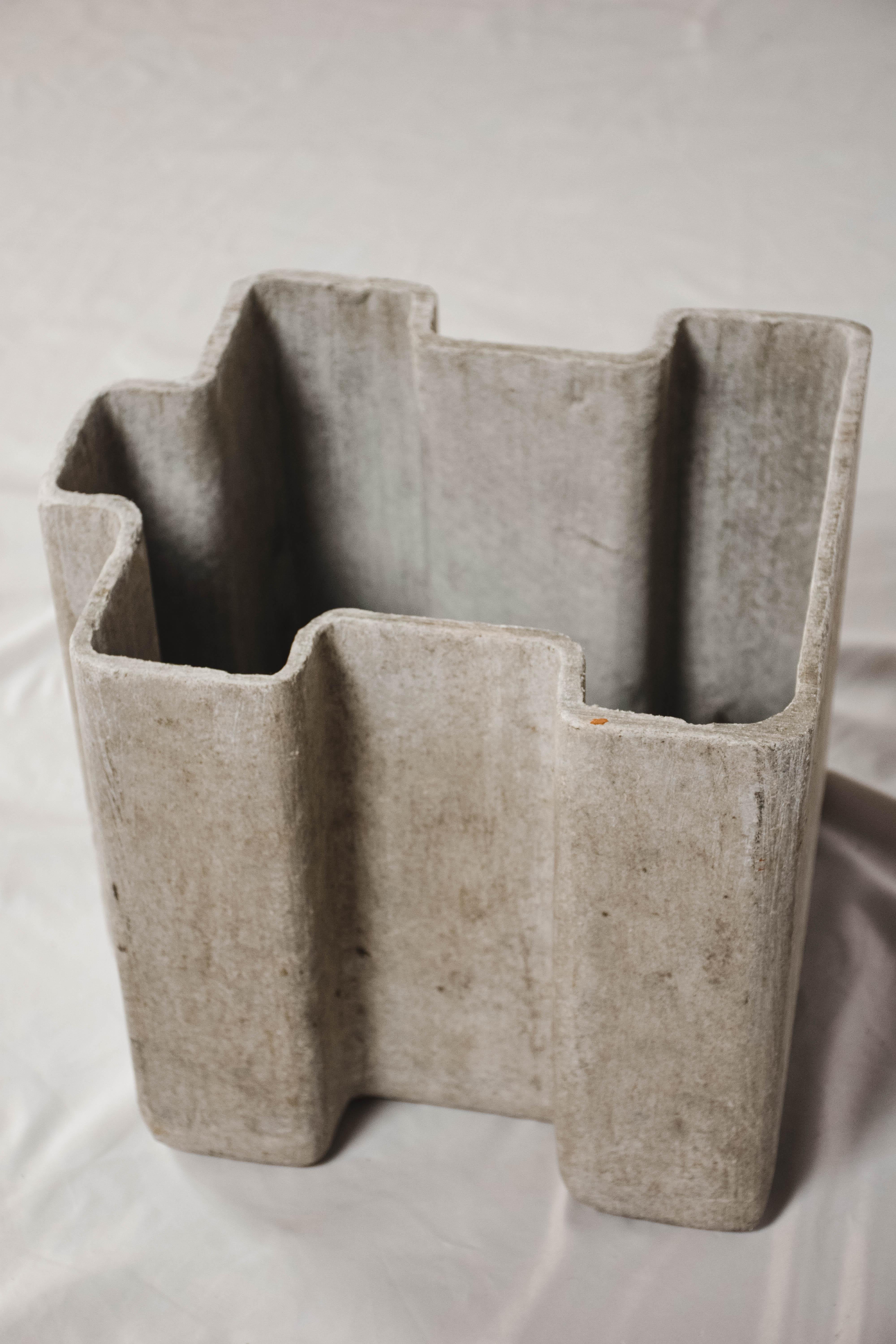 Found in France and created in the mid-20th century, this rare Willy Guhl puzzle piece planter is perfect for indoor or outdoor use. This sculptural piece is the design of Swiss architect Willy Guhl. Made of cement, this piece has a distinct style