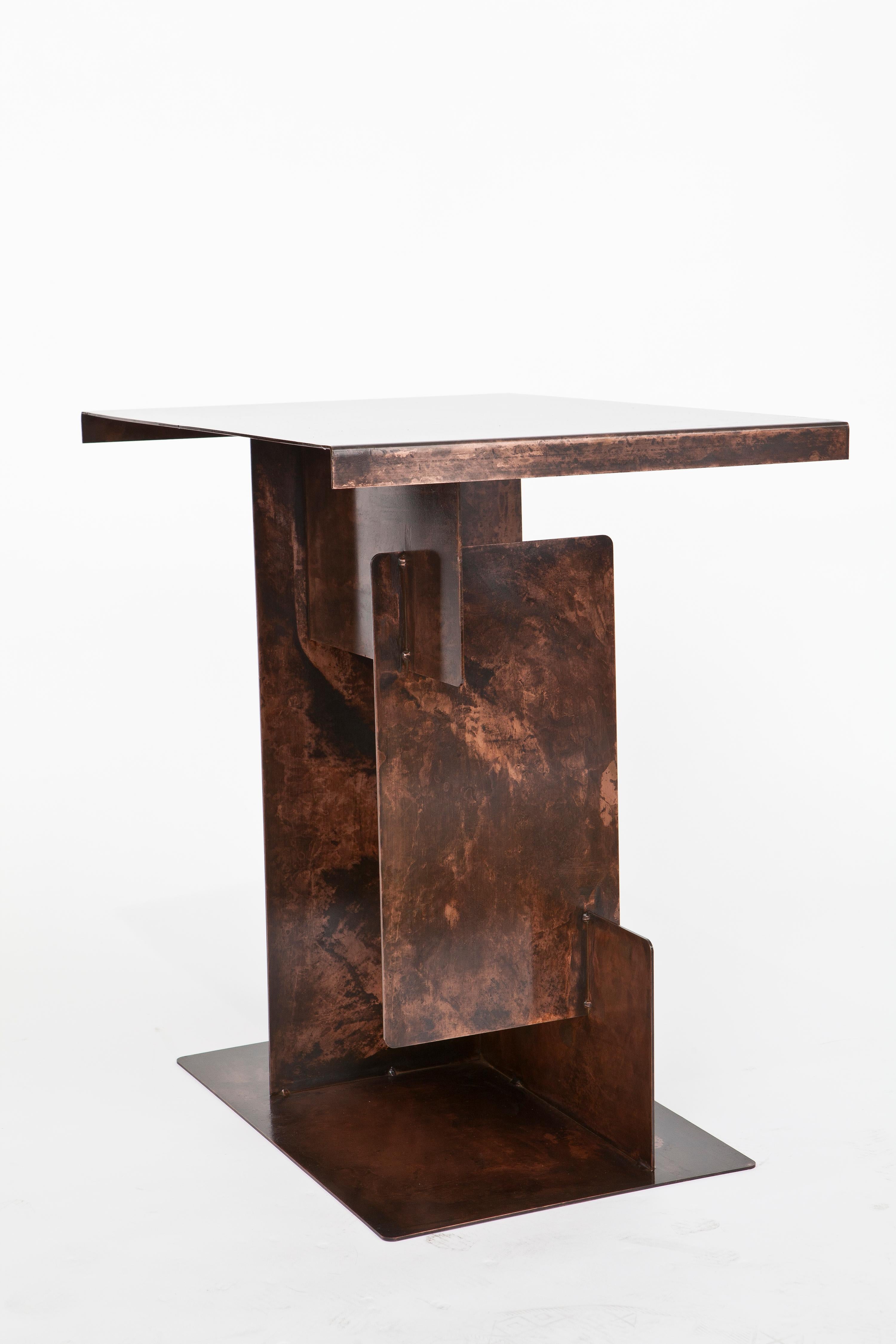 Puzzle side table by Egg Designs
Dimensions: 61.5 L x 45 D x 63.5 H cm 
Materials: Antique copper, plated steel.

Founded by South Africans and life partners, Greg and Roche Dry - Egg is a unique perspective in contemporary furniture inspired