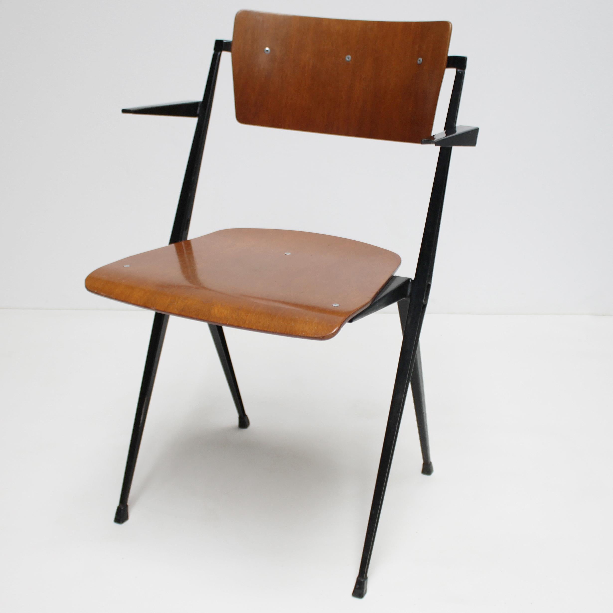 Pyramid armchair by Dutch designer Wim Rietveld for De Cirkel, Holland. Lacquered steel frame with a plywood seat and backrest. Stamped with date of production: 23 December 1965 (see picture).
Dimensions: Height 31.9 in. (81 cm), width 20.9 in. (53