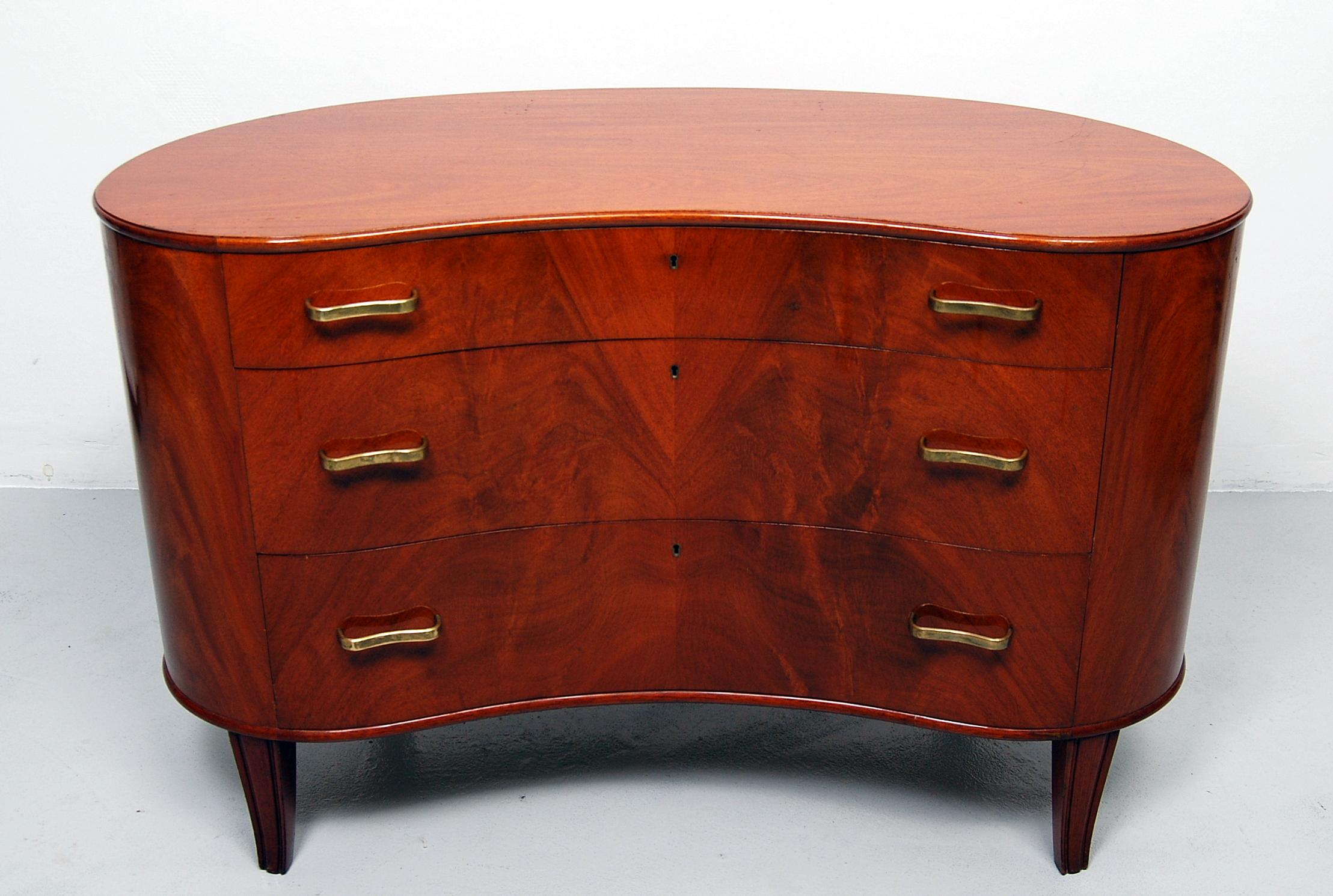 Rare and beautiful chest of drawers designed by Axel Larsson for SMF Bodafors in the 1940s. A top quality, kidney shaped piece of furniture with curved, solid brass handles. The inside of the three drawers are like new. This chest of drawers are in