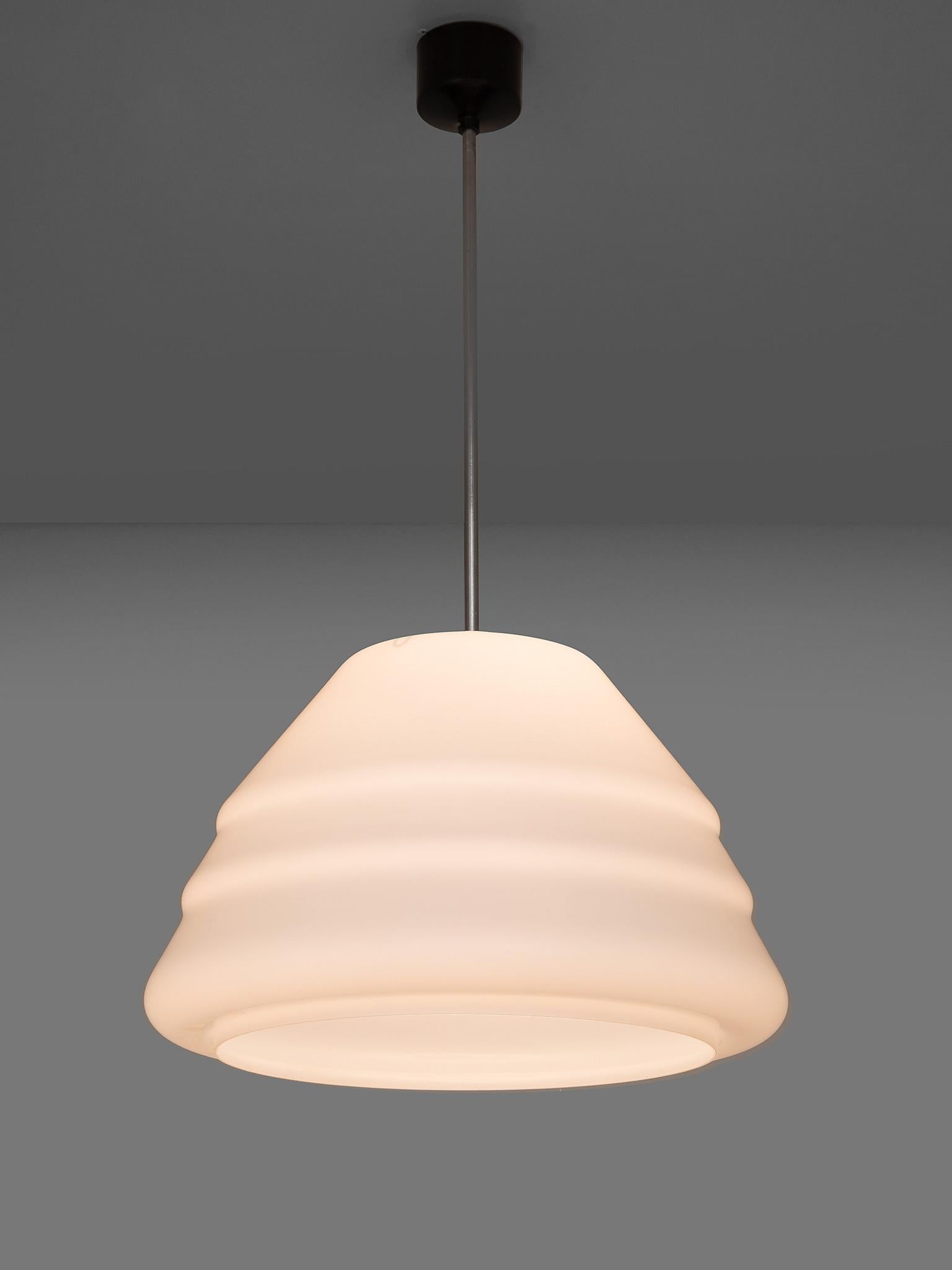 Pendant, opaline glass, metal, Europe, 1970s.

This lush, curvy shape is built up of a waved pyramid-like shape. This organic shape, combined with opaline glass, results in a stunning soft light partition. The contrast of this voluptuously shaped