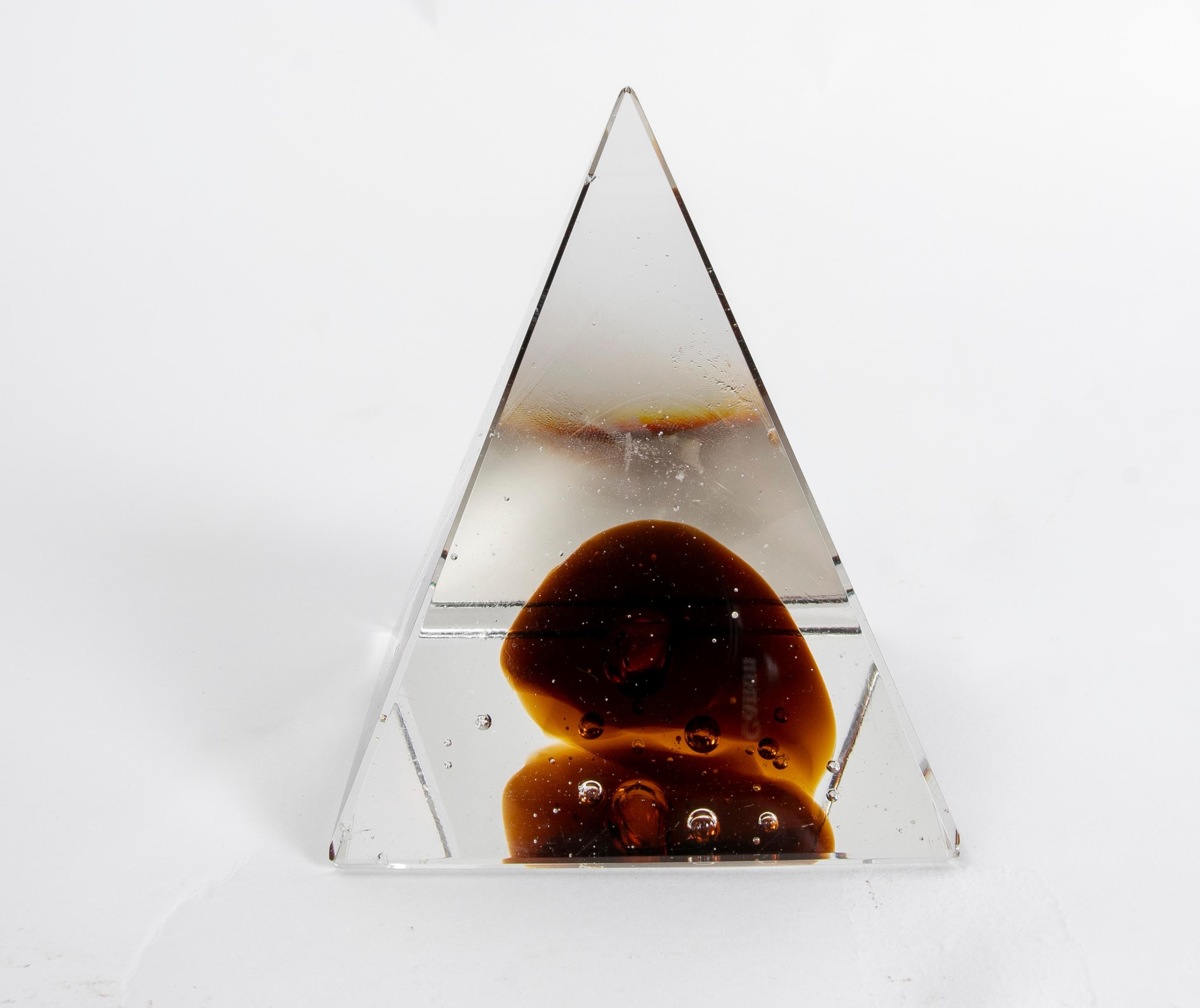 Pyramid-shaped glass paperweight.