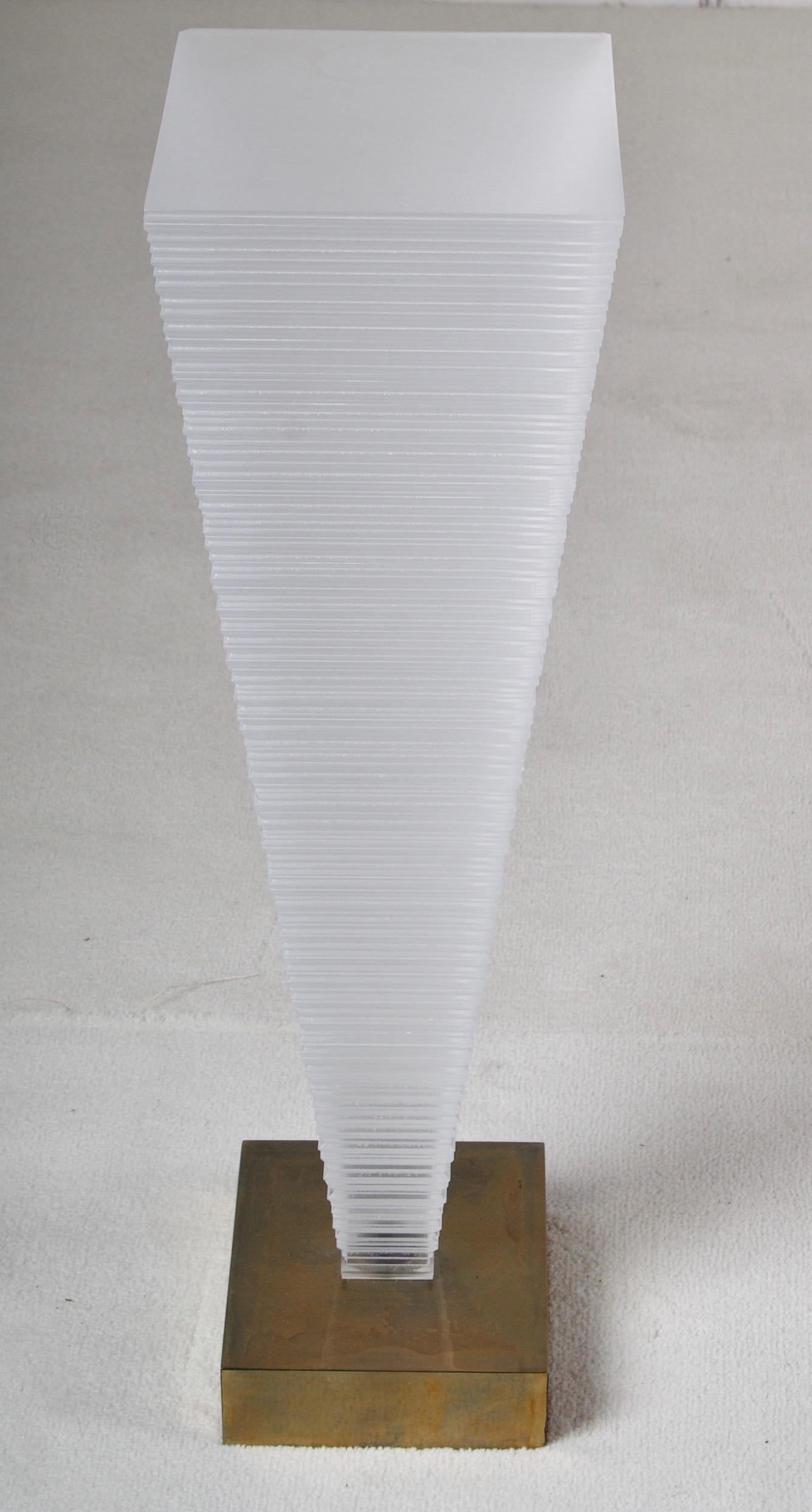 A very stylish side table fabricated by Leavitt and Weaver
In carved Lucite with a bronze base.