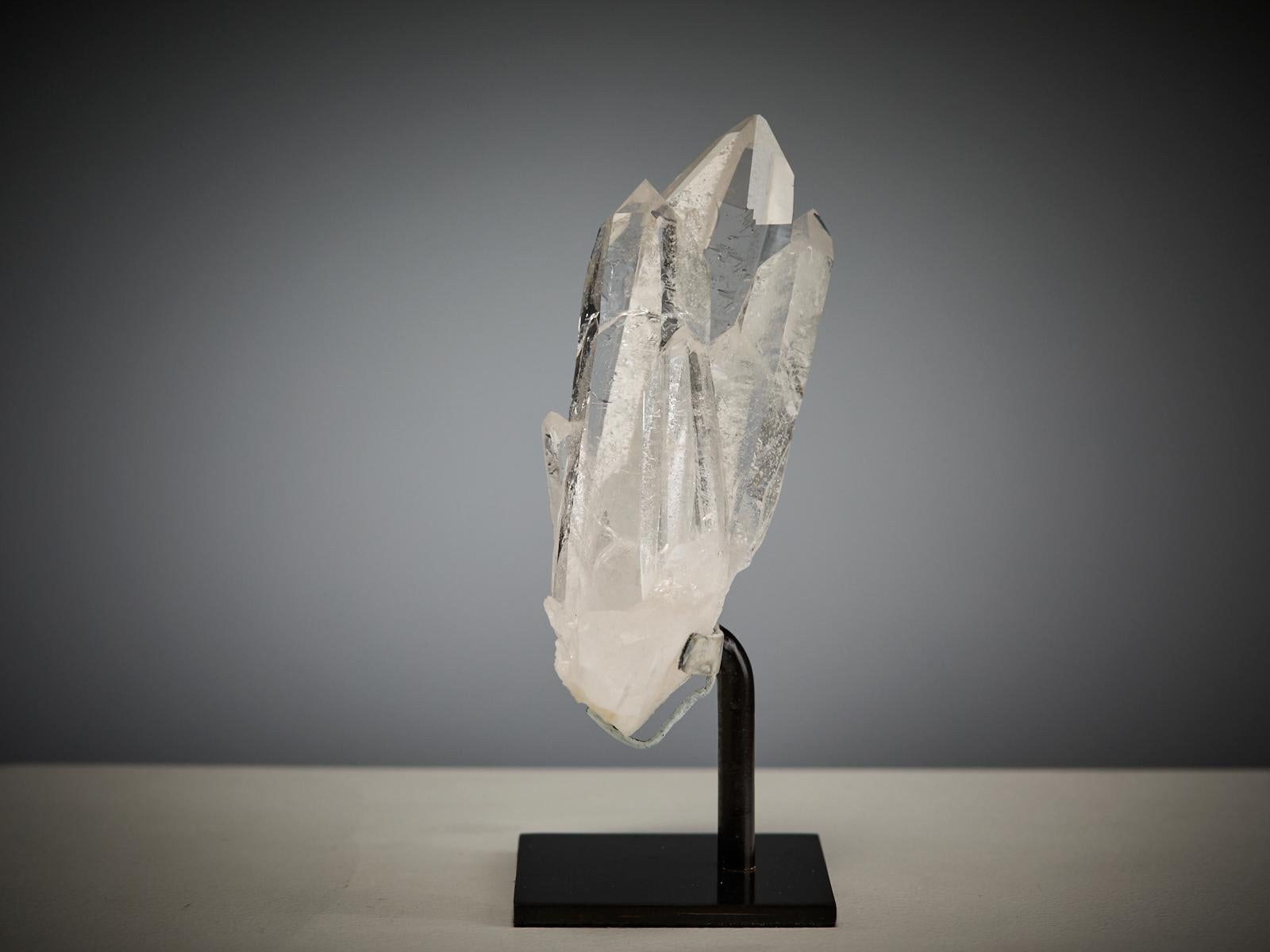 This beautiful quartz cluster from the Cabaçaco Claim, Minas Gerais, Brazil, is composed of several transparent crystals growing together in a pyramidal shape. The overlapping formations create a gentle sense of movement, while subtle internal