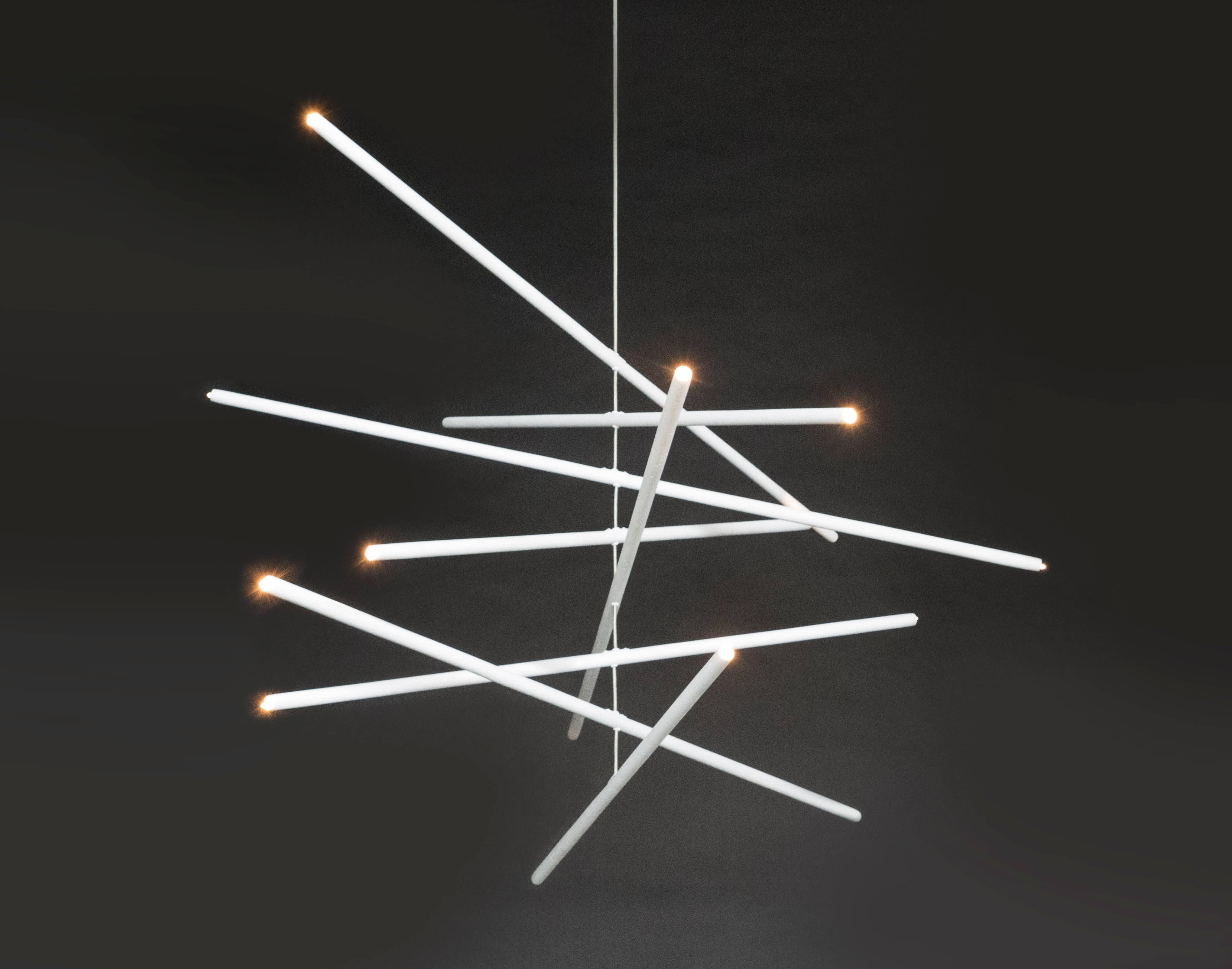 This intriguing chandelier floats in the air like a mobile. The hand finished plaster rods are fitted with low voltage halogen sockets and are suspended from a woven stainless steel wire. The sixteen lights provide a perfect ambience and light the