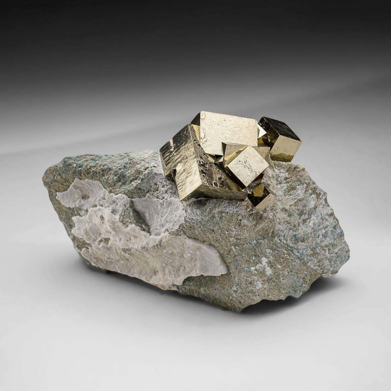 Sharp cubic metallic pyrite crystals in tan-colored Basalt matrix. The pyrite crystal has smooth crystal faces with almost mirror-like luster, stands upright nicely without additional support. A must-have for any collection, these unique formations
