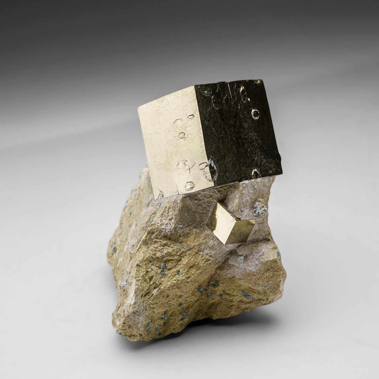 Sharp cubic metallic pyrite crystal in tan-colored Basalt matrix. The pyrite crystal has smooth crystal faces with almost mirror-like luster, stands upright nicely without additional support. A must-have for any collection, these unique formations