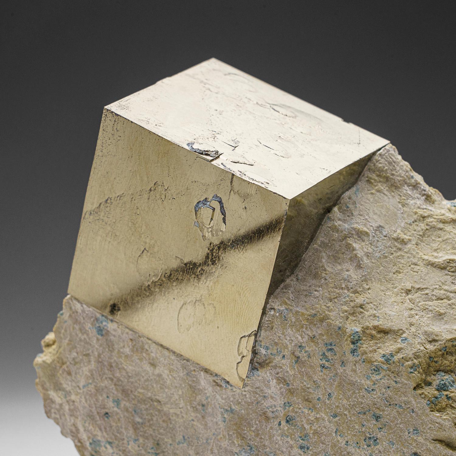 A large sharp cubic metallic pyrite crystal in tan-colored Basalt matrix. The pyrite crystal has smooth crystal faces with almost mirror-like luster, stands upright nicely without additional support. A must-have for any collection, these unique