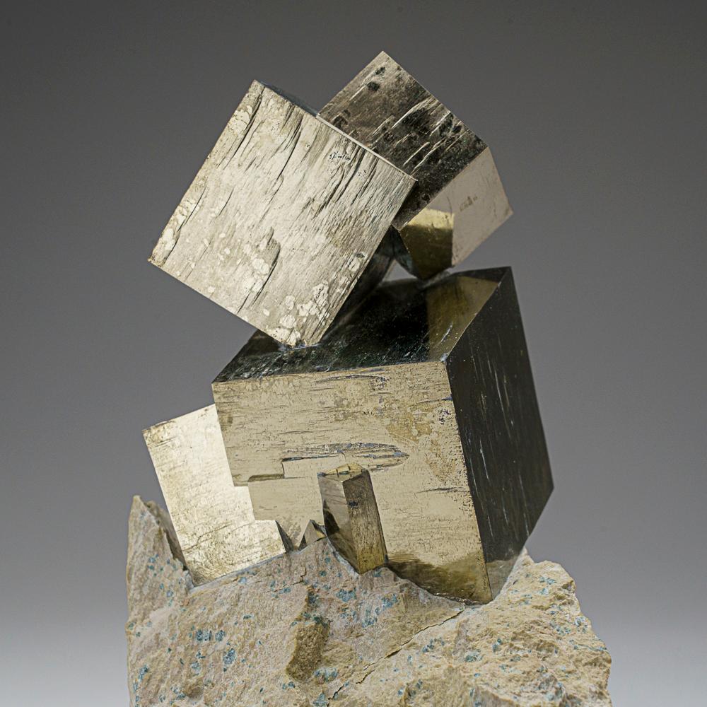 Three large cubic pyrite crystal across intergrown perched on Basalt matrix. The pyrite crystals have smooth faces and sharp edges, stands upright nicely without additional support. A must-have for any collection, these unique formations are formed