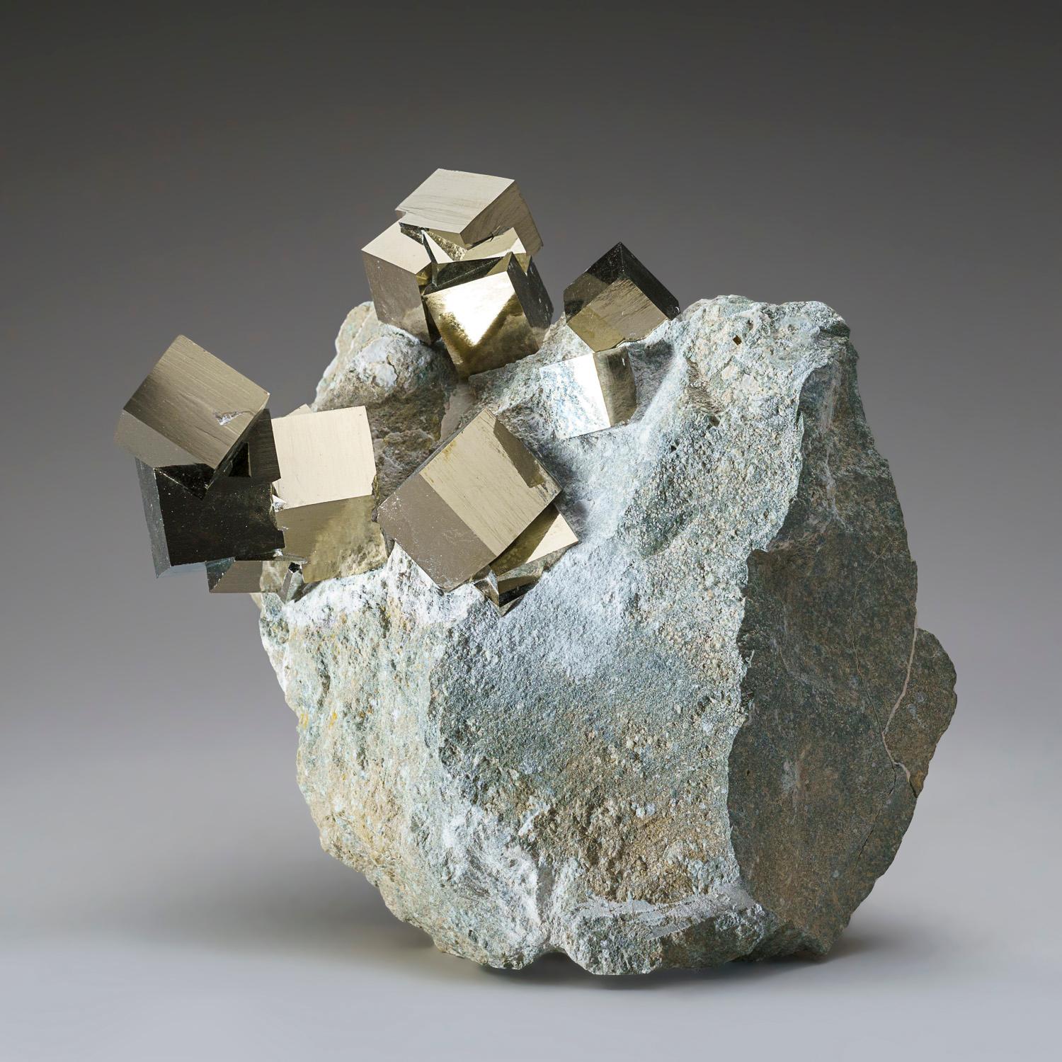 Several large cubic pyrite crystal across intergrown perched on Basalt matrix. The pyrite crystals have smooth faces and sharp edges, stands upright nicely without additional support. A must-have for any collection, these unique formations are
