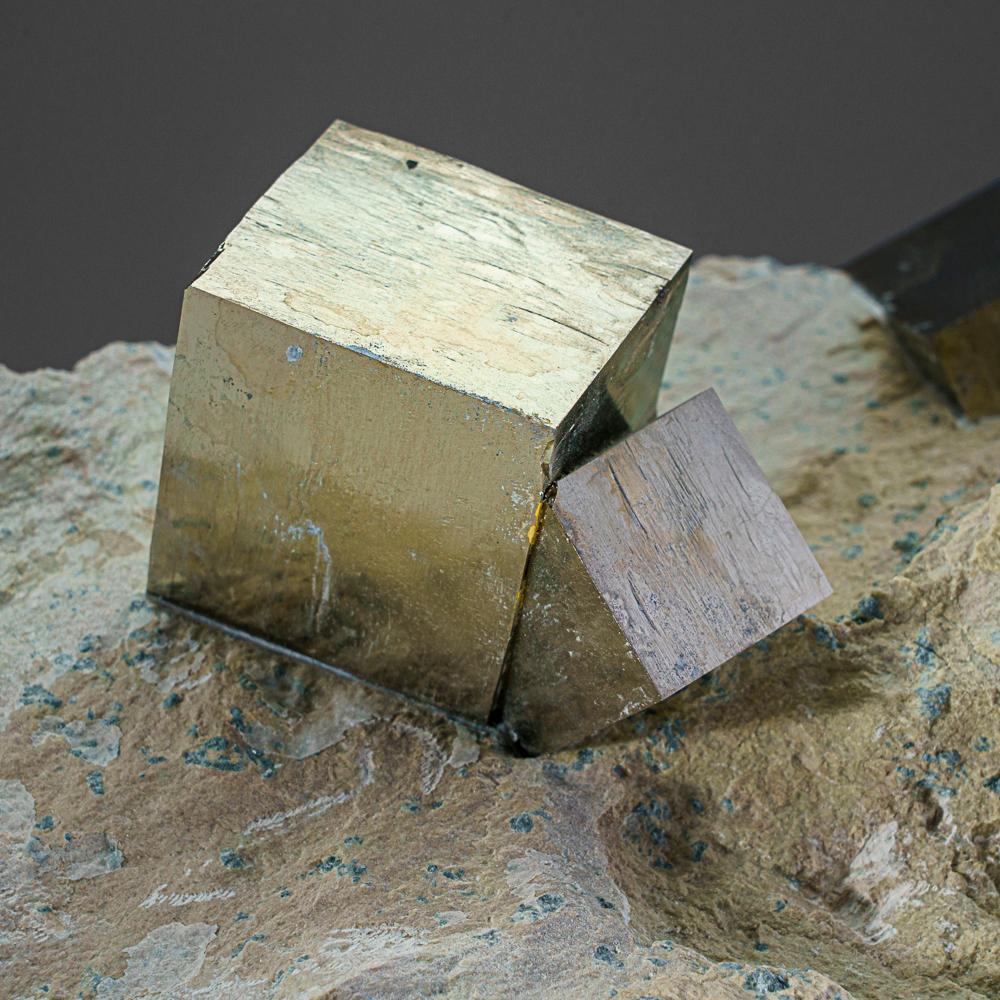 Three large cubic pyrite crystal across intergrown perched on Basalt matrix. The pyrite crystals have smooth faces and sharp edges, stands upright nicely without additional support. A must-have for any collection, these unique formations are formed