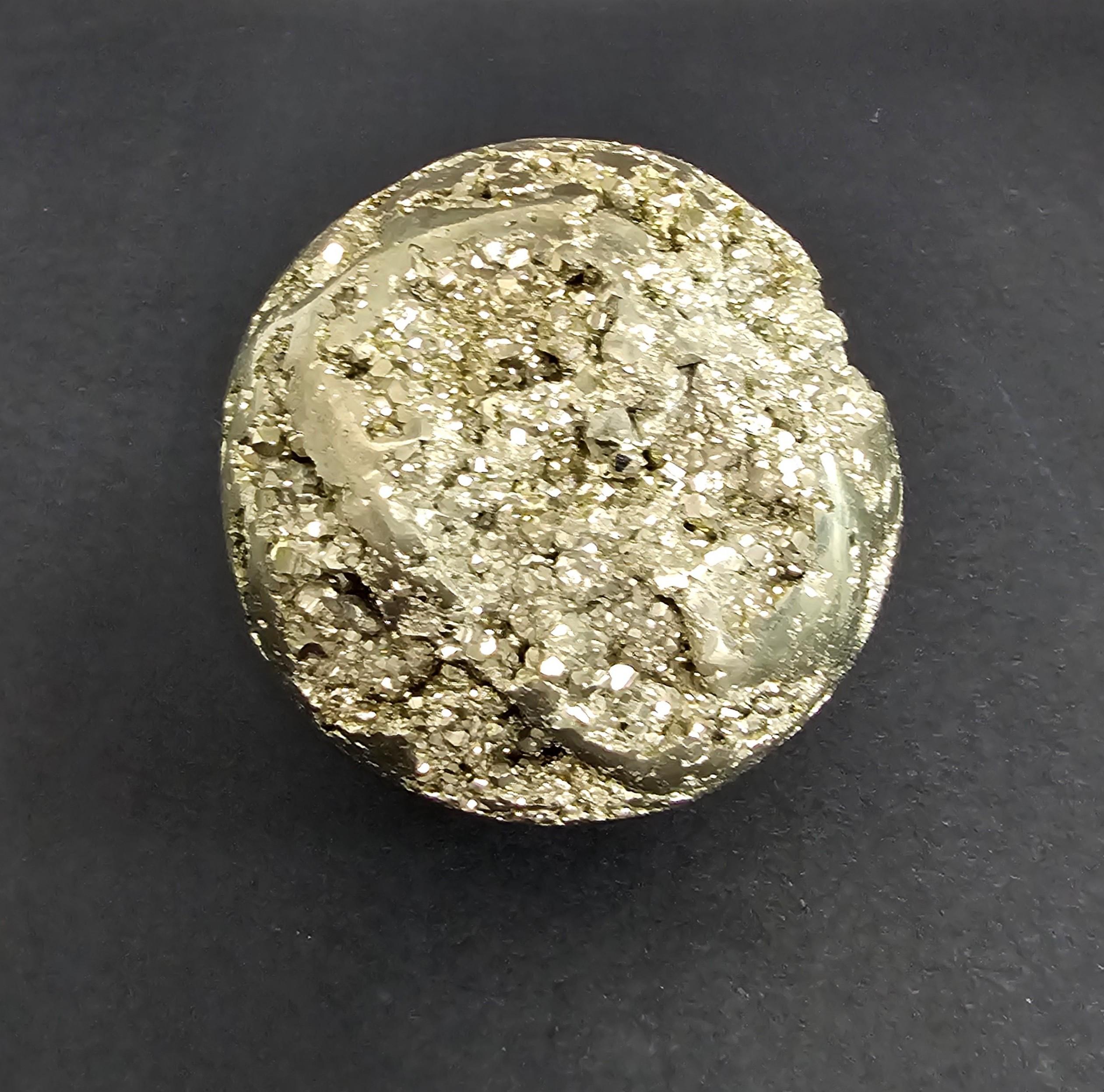 A visually striking Peruvian Pyrite sphere! Fairly large and heavy, this massive sphere of brillant metallic Pyrite is a study in duality, with a large section of the exterior surface polished smooth and round, while the resplendent cavities are