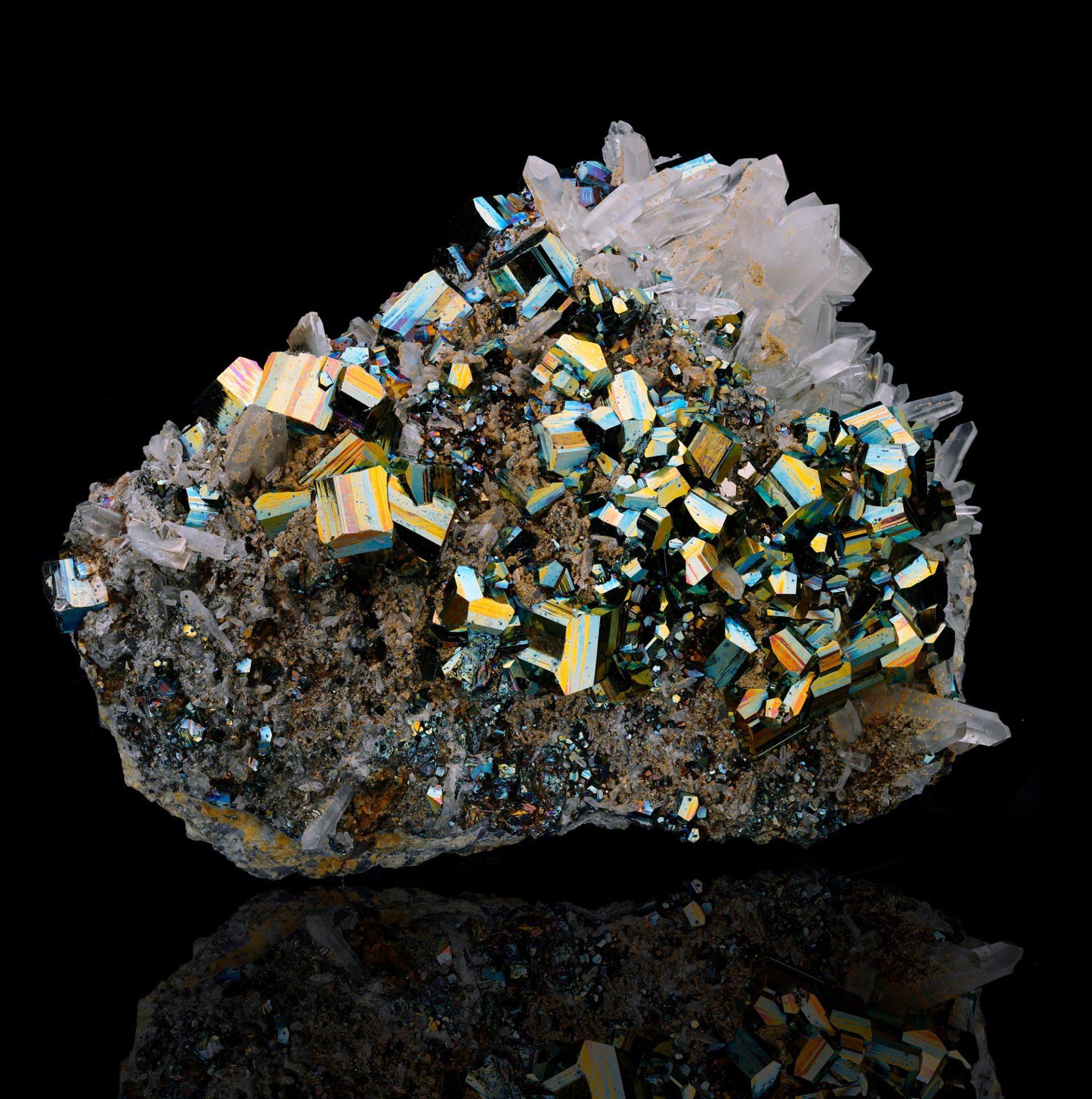 This striking large Pyrite on Quartz combination mineral specimen from Indonesia features sharply defined octahedral Pyrite crystals naturally intergrown with clear Quartz points. Trace amounts of Arsenopyrite delicately coat the Pyrite surfaces,