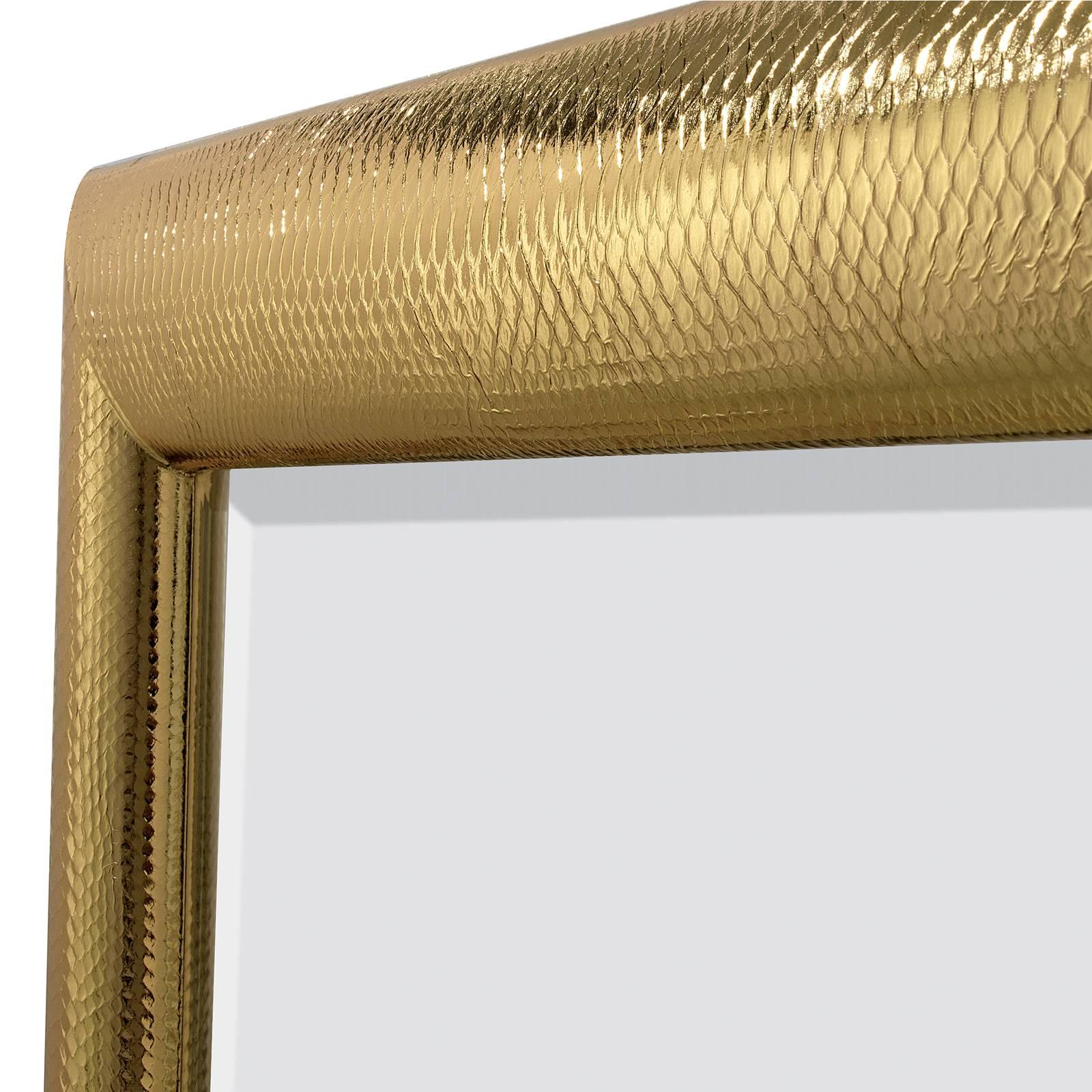 Sumptuous and elegant, this stunning mirror boasts a genuine python leather upholster over the wooden frame that was covered in striking gold. The effect is a unique piece of functional decor that will be a perfect complement to a colorful