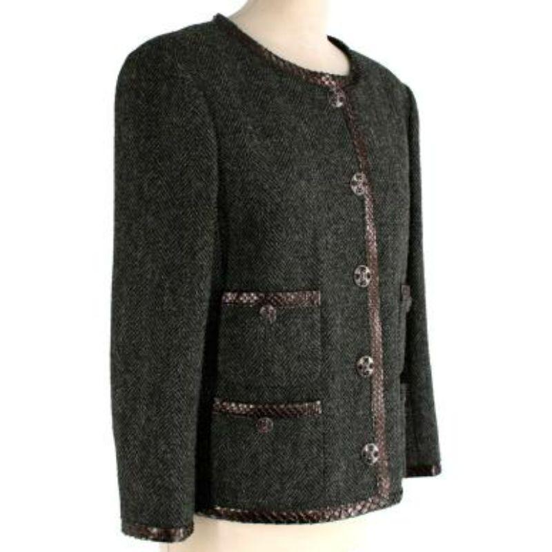 Chanel Python Trim Herringbone Jacket
 
 -Fully edged in metallic brown python trim 
 -Four bejeweled Chanel logo buttons fastening pockets
 -Buttons fastening closure through front
 -Fully lined 
 -Buttoned cuffs 
 -Pre-Fall 2013 Karl Lagerfield
